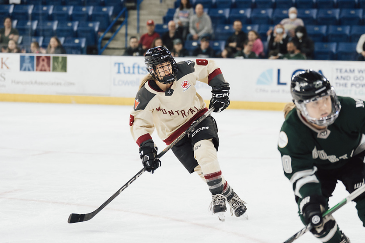 David opens up for a pass during a playoff game. She is watching the play to her left while wearing a cream away jersey.