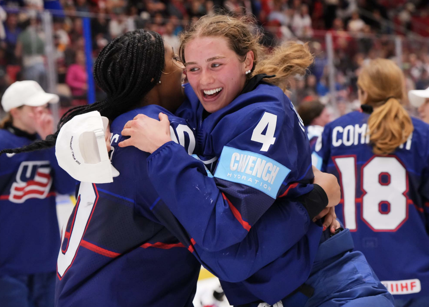 Edwards (left) and Harvey (right) embrace during the postgame celebration. They are wearing blue uniforms.
