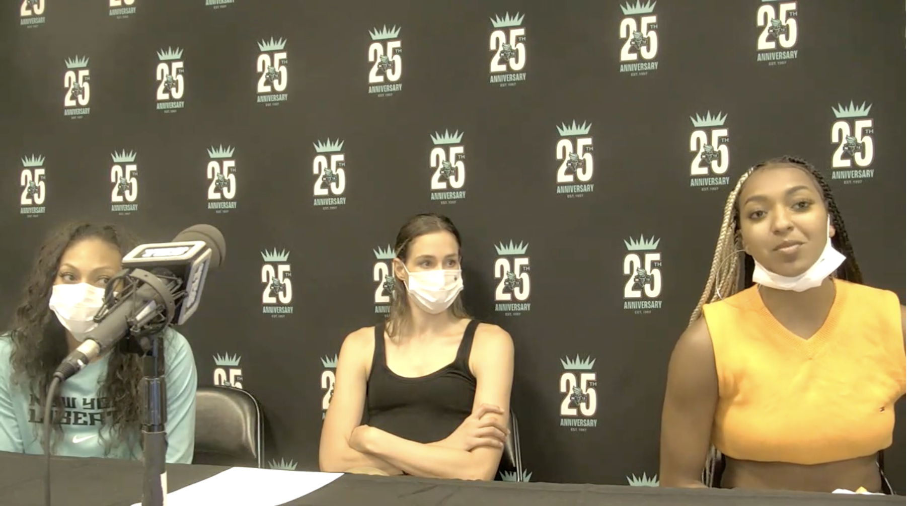 DiDi Richards of the New York Liberty talks to media postgame while Betnijah Laney and Rebecca Allen look on, August 25, 2021. (Screenshot via WNBA Content Network)