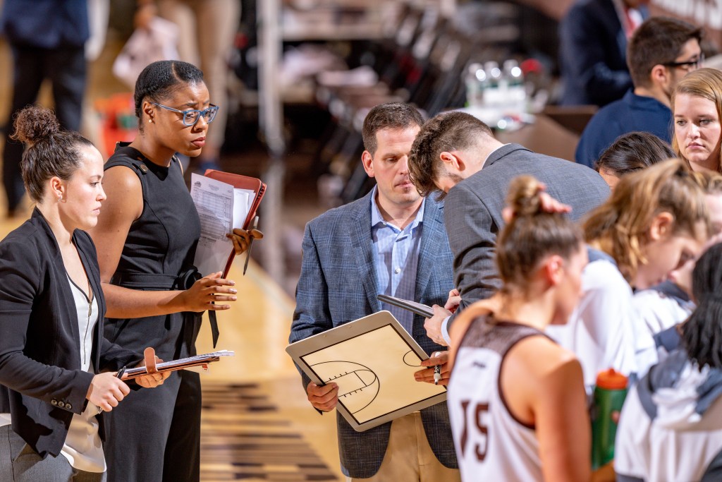 Amber Easter and the rest of the St. Bonaventure coaching staff in the Huddle.
