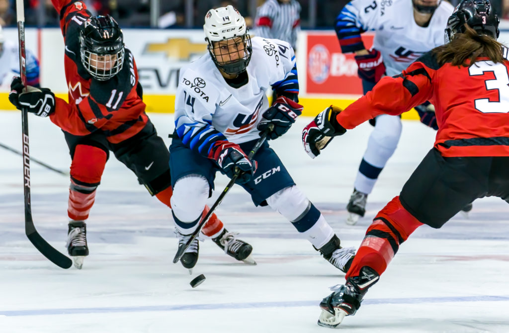 Briana Decker puck handles through Canadian defense. Photo by Matthew Raney.