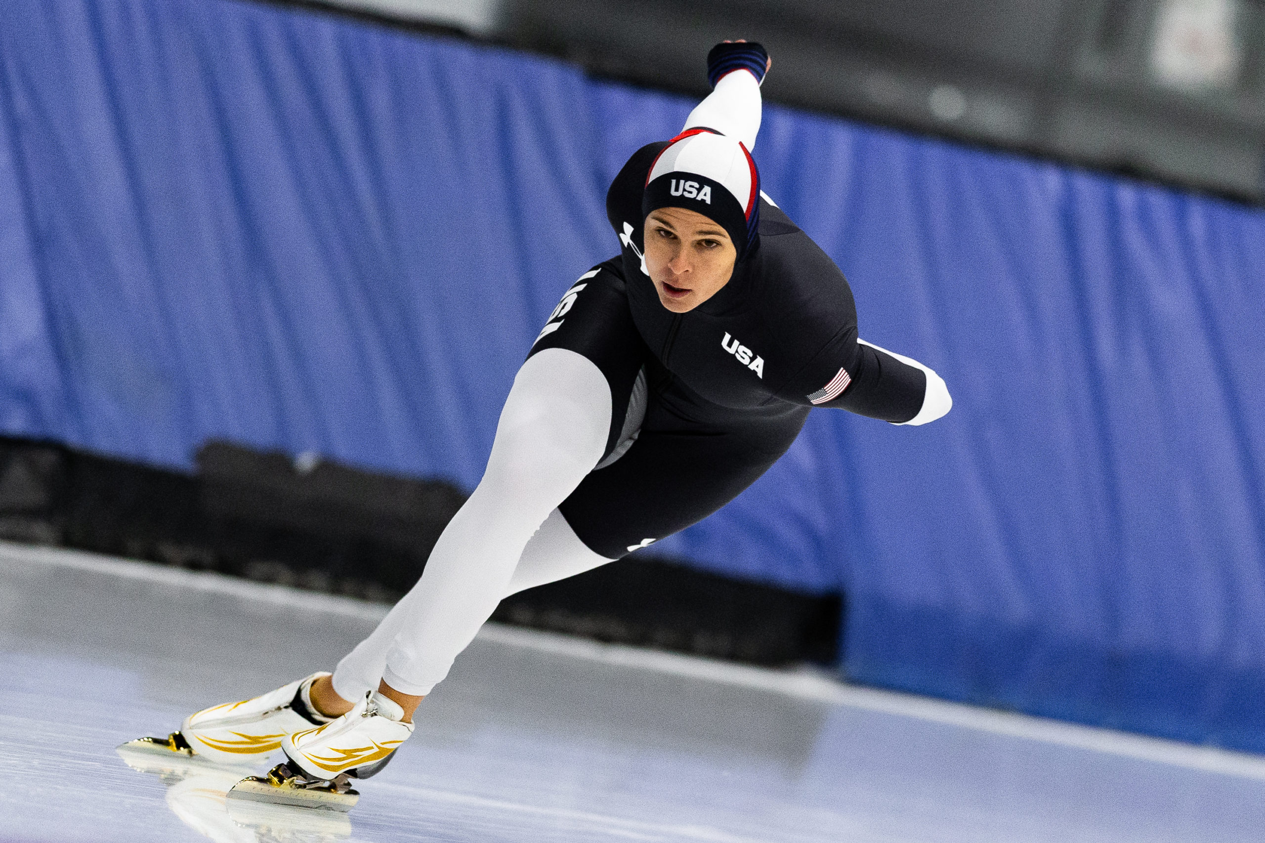 Speedskater Brittany Bowe leans forward while skating.