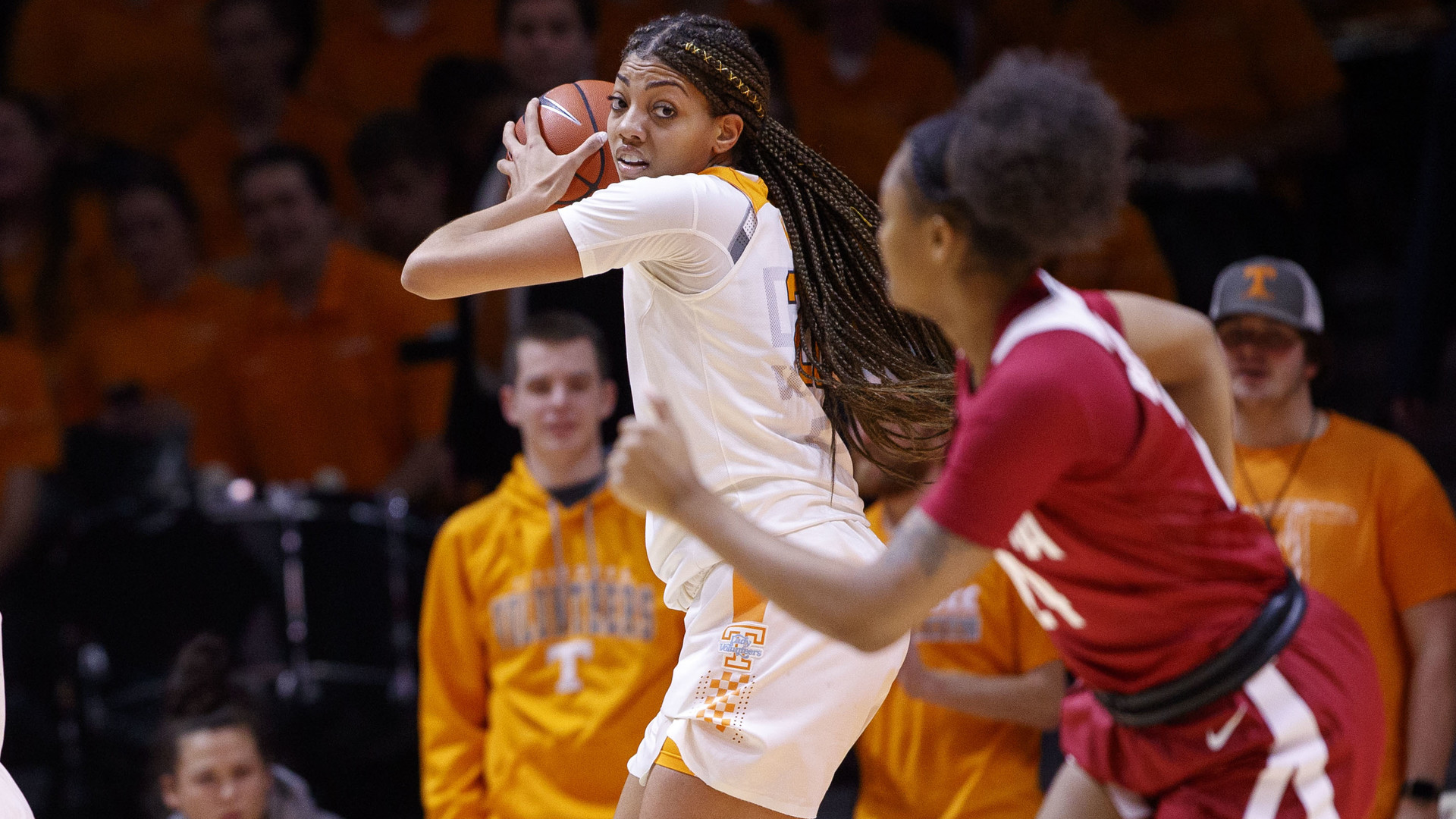 Tennessee senior Tamari Key posts up against a defender while wearing number 20 on classic Tennessee orange and white uniforms.