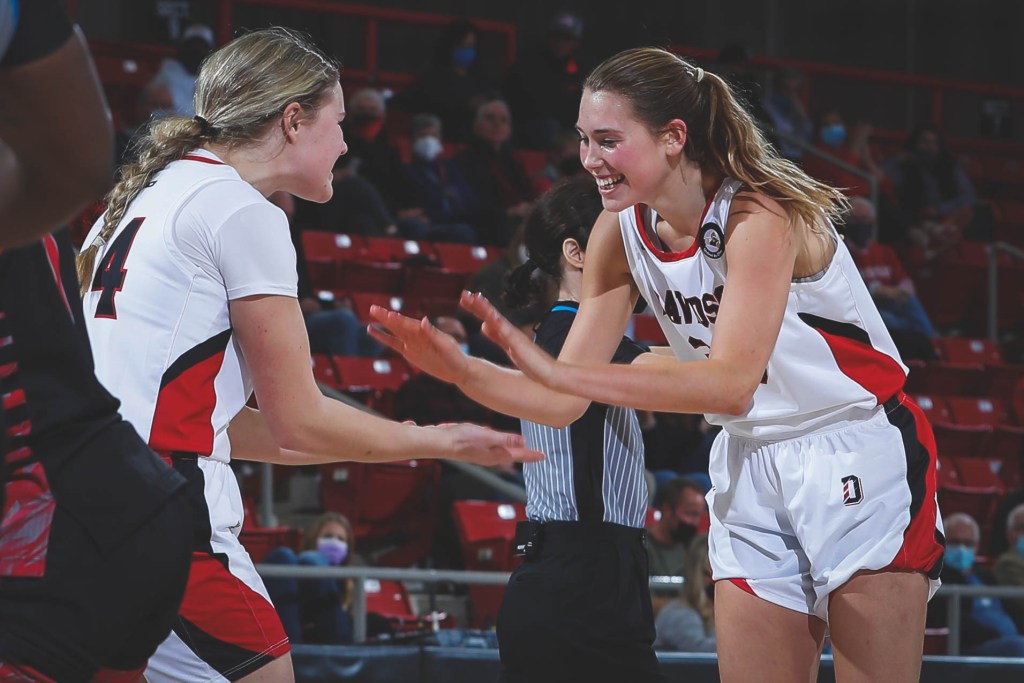 Elle Sutphin high-fives her teammate