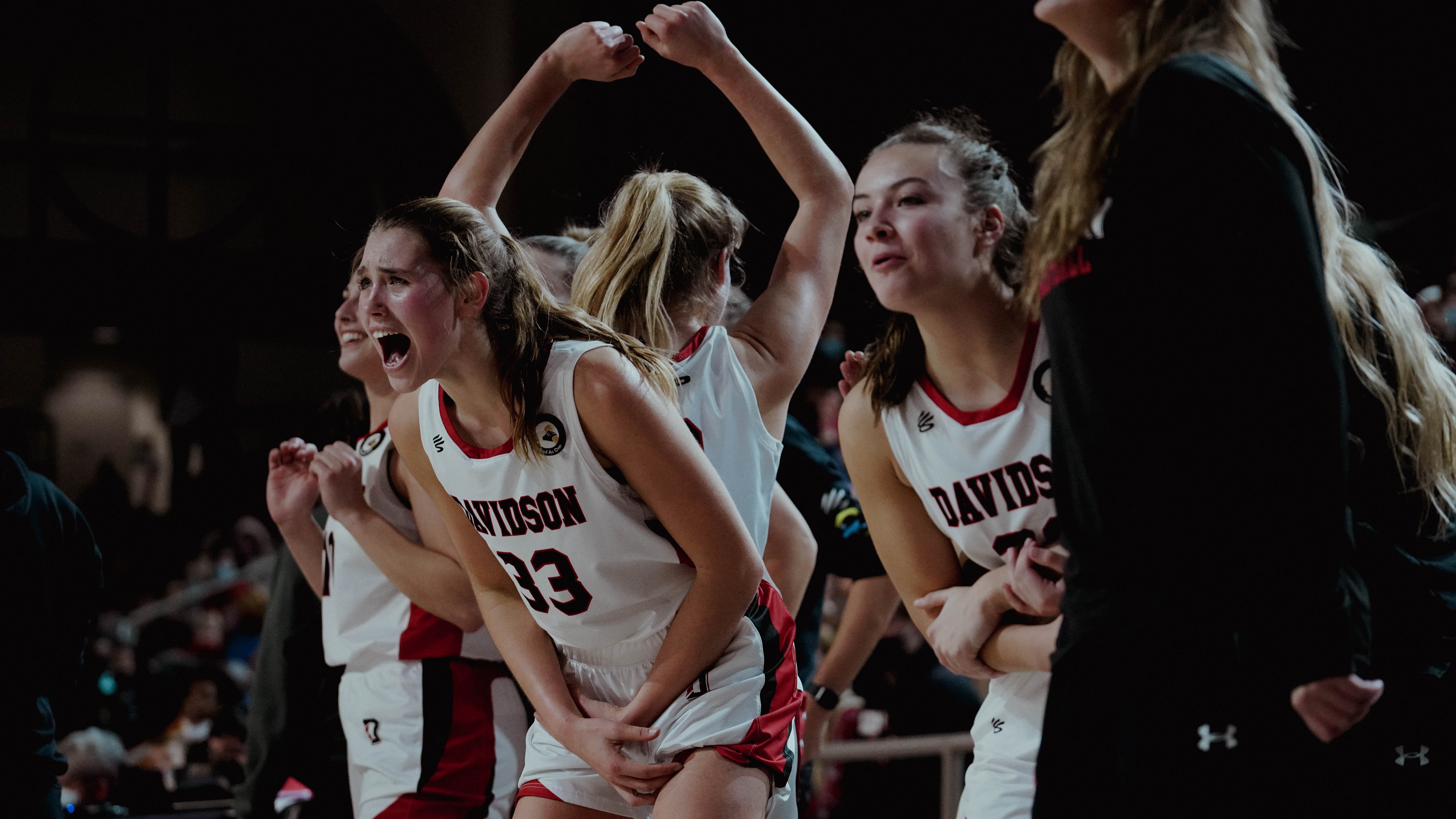 Elle Sutphin celebrates with her team on the sideline.