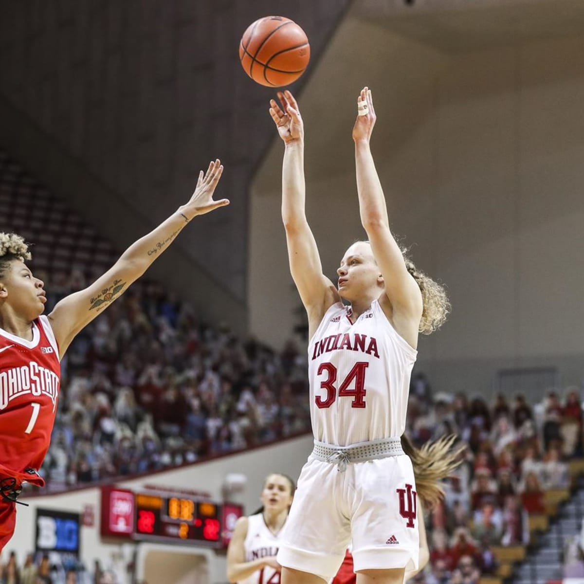 Grace Berger begins to flick her wrist as the ball leaves her hand on a jump shot over an outstretched defender.