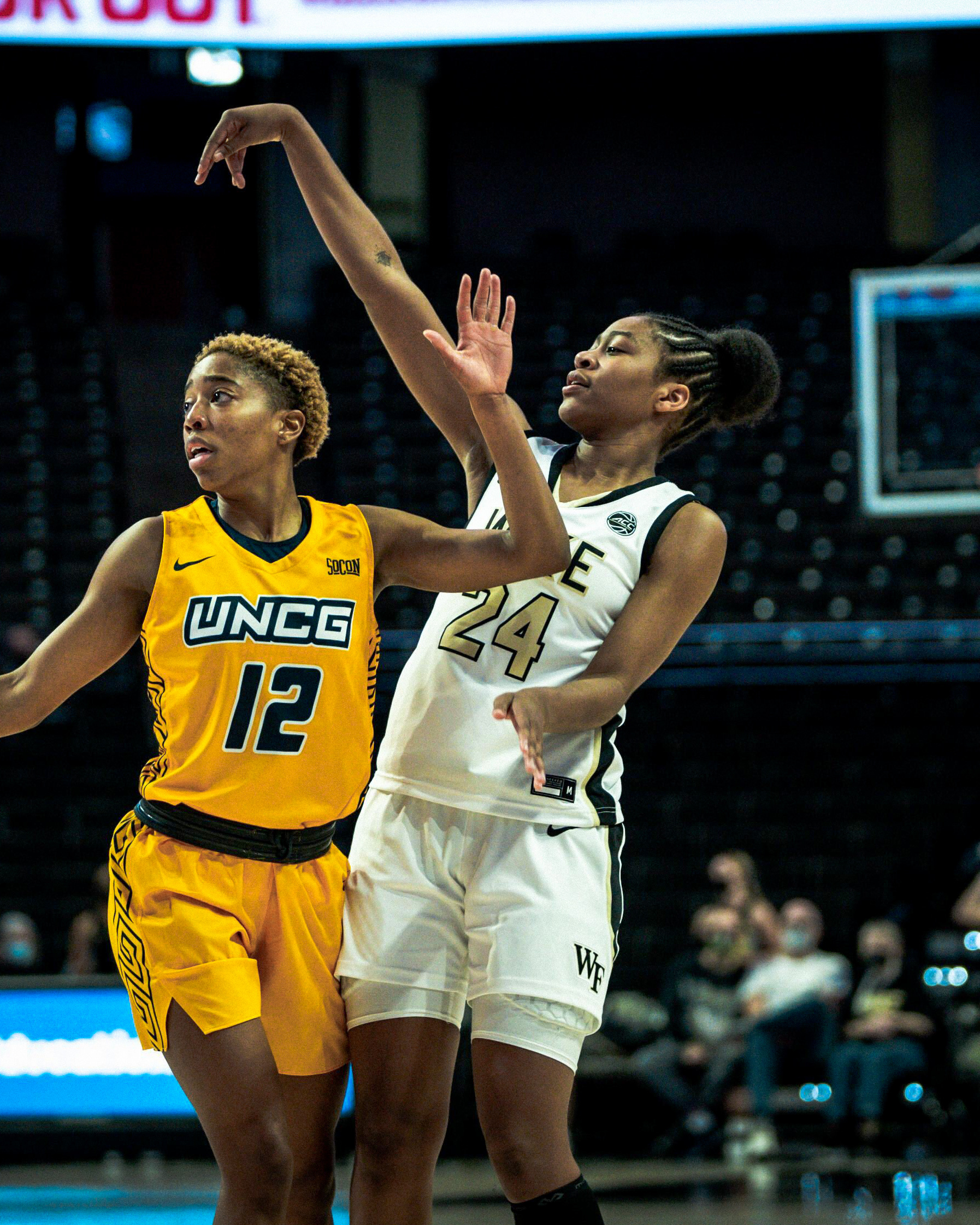 Jewel Spear holds her follow-through after taking a jump shot with a UNC-Greensboro defender in her face.
