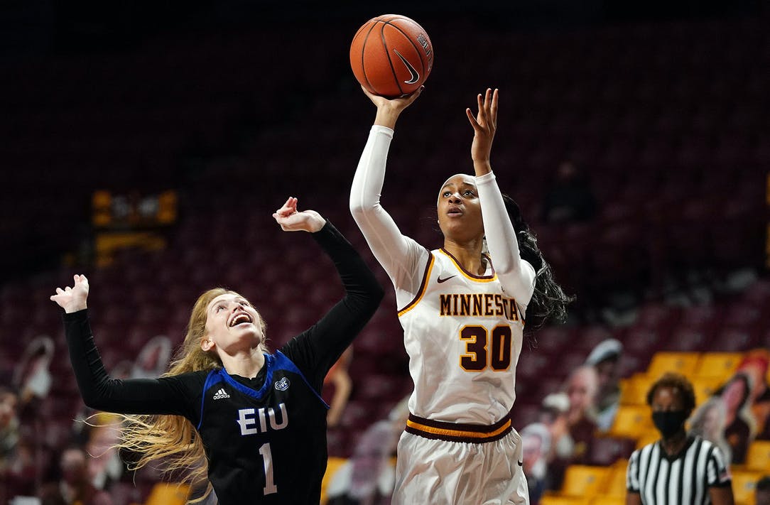 Kadiatou Sissoko goes up for a basket as a defender races to defend.