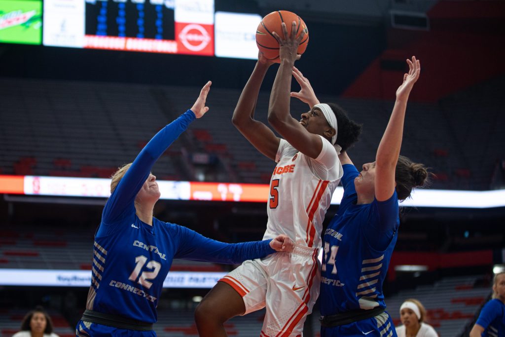 Teisha Hyman shoots a fadeaway while sandwiched between two defenders