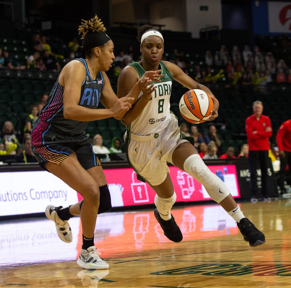 Kennedy Burke tries to dribble left around her defender from the right slot