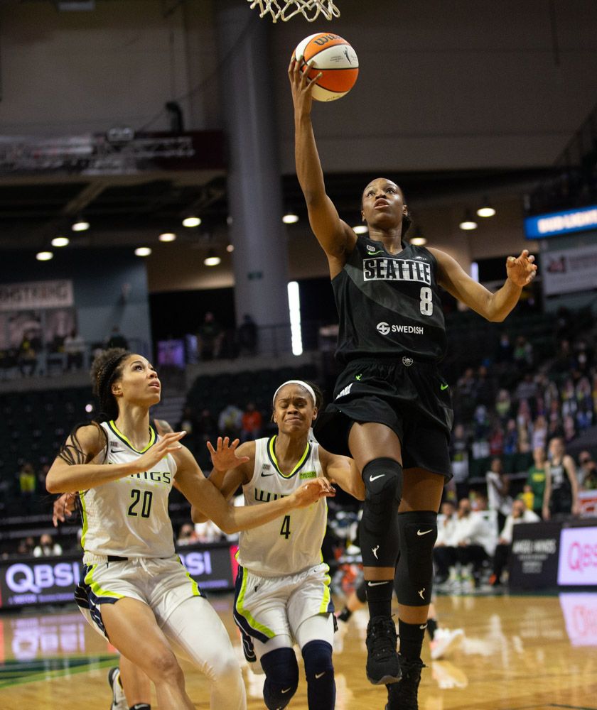 Kennedy Burke goes up for a layup as two defenders right behind her watch
