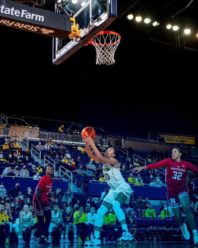 Naz Hillmon prepares to go up for a barely-contested layup, her upper body lit normally but her lower body shaded in bluelight