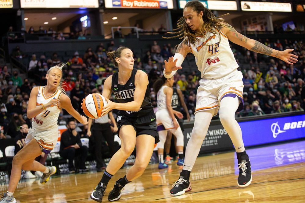 Stephanie Talbot looks to pass around a sliding Brittney Griner, with Sophie Cunnigham trying to catch up from behind