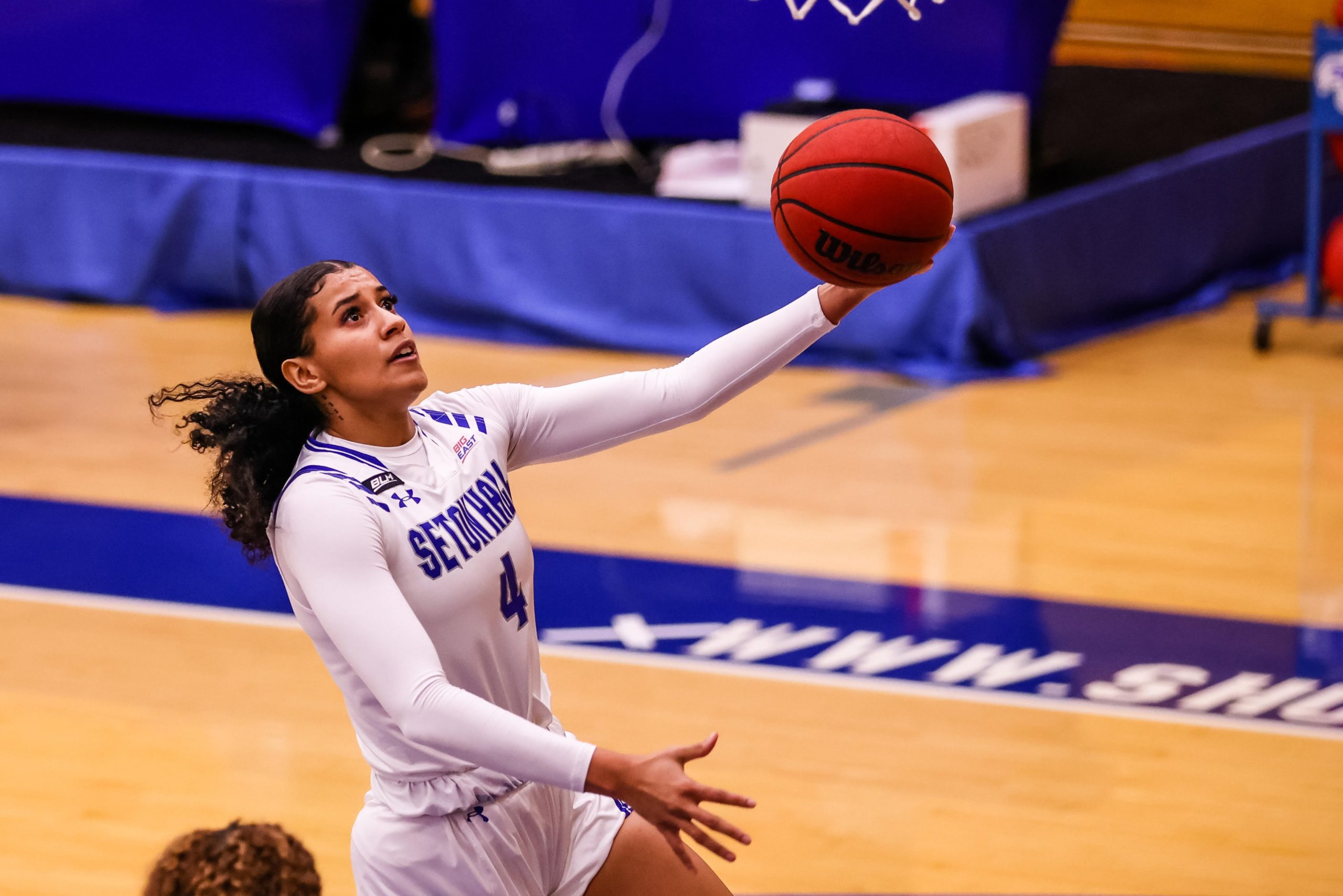 Andra Espinoza-Hunter rises in midair towards the hoop, raising her left hand to lay up the ball