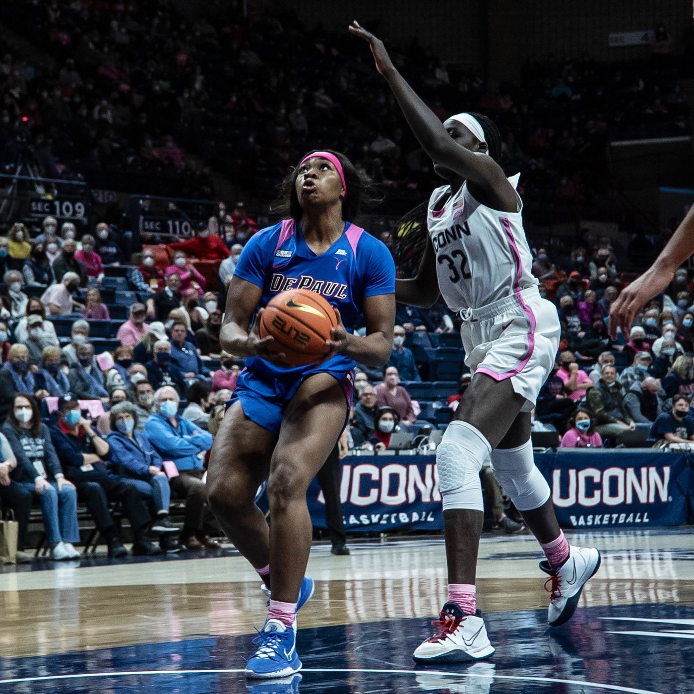 Aneesah Morrow blows by a defender while readying to go up for a layup, as the defending raises her arm to attempt to block from behind
