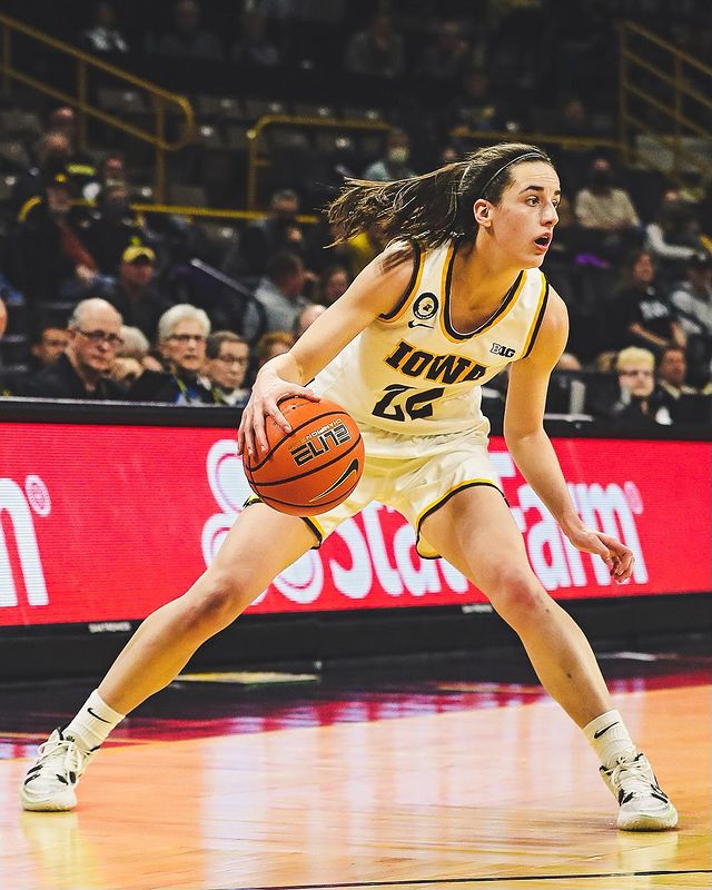 Caitlin Clark opens her stance to perform a crossover-stepback