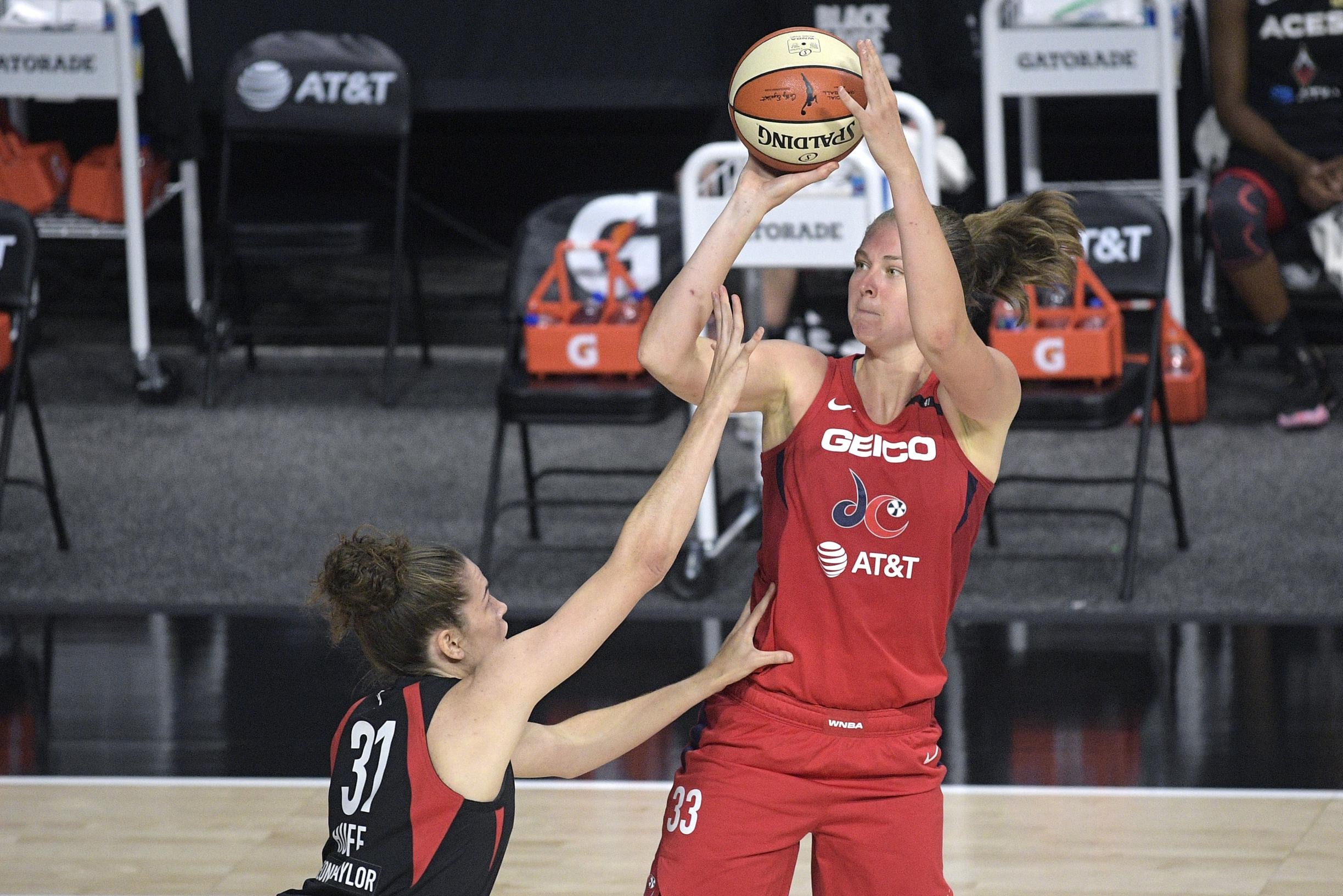 Emma Meesseman takes a fadeaway jumper with Megan Huff attempting to rise to contest