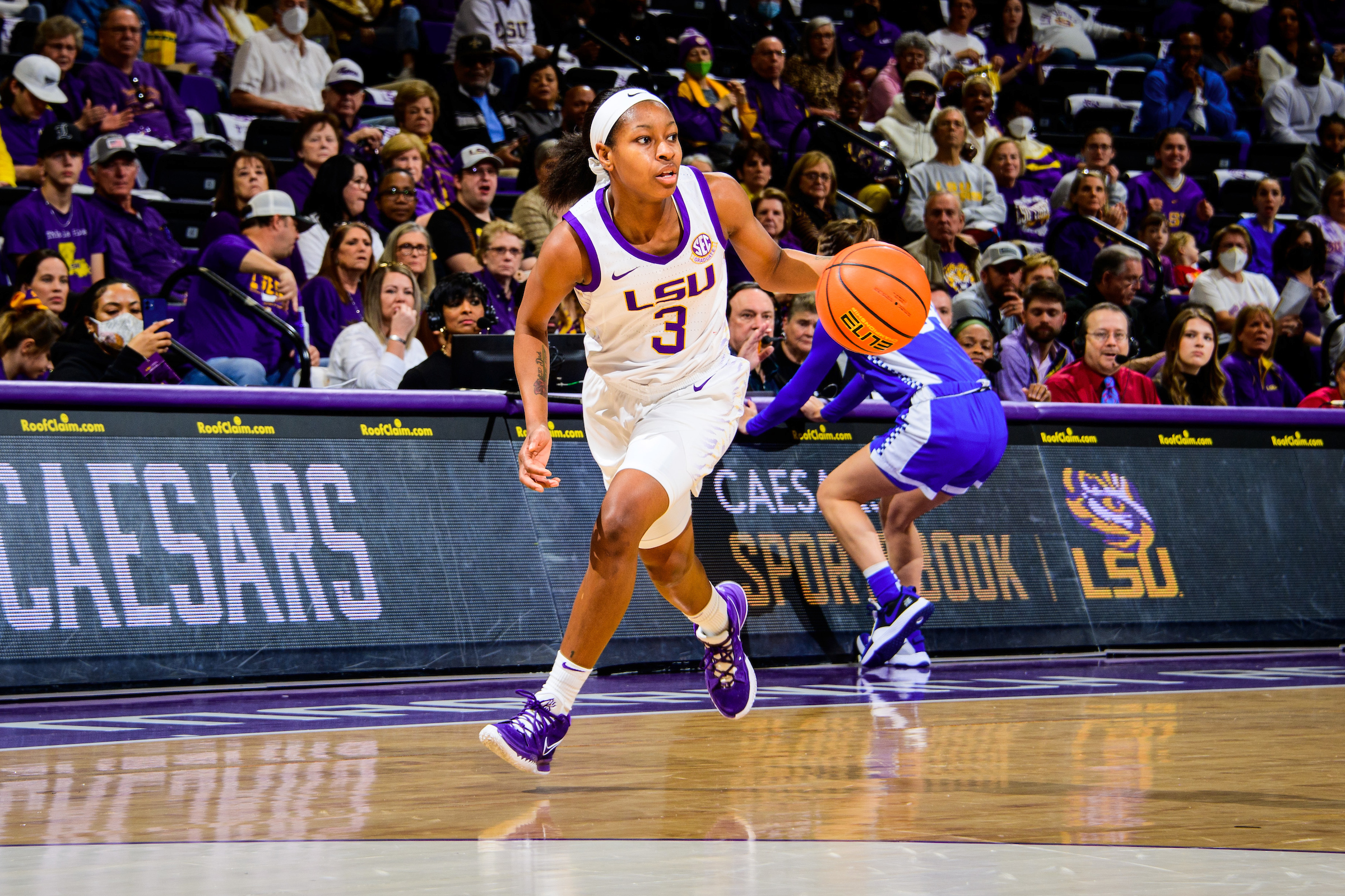 Khayla Pointer looks towards the middle of the court while dribbling down the slot