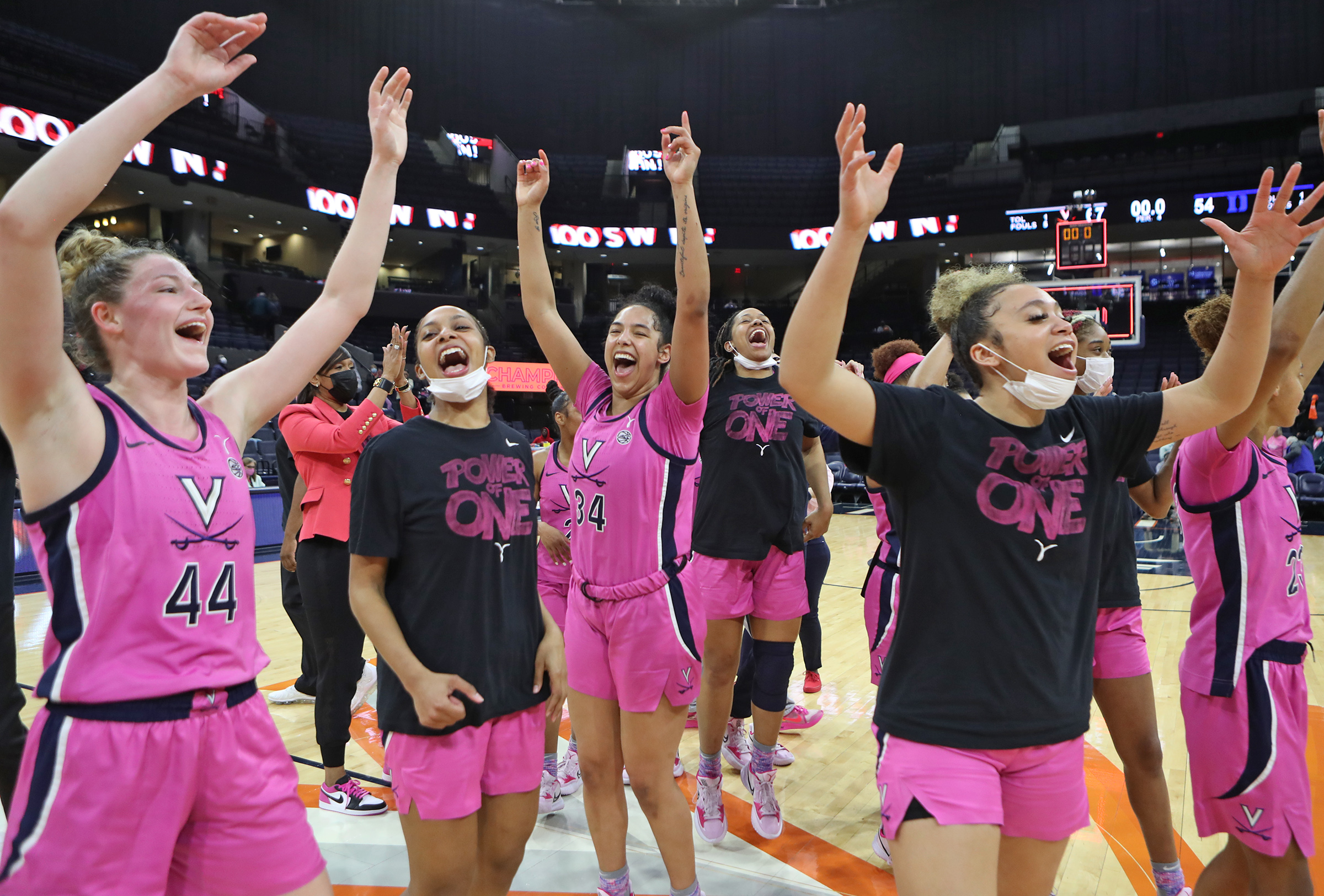 Members of the Virginia team celebrate at halfcourt after the game