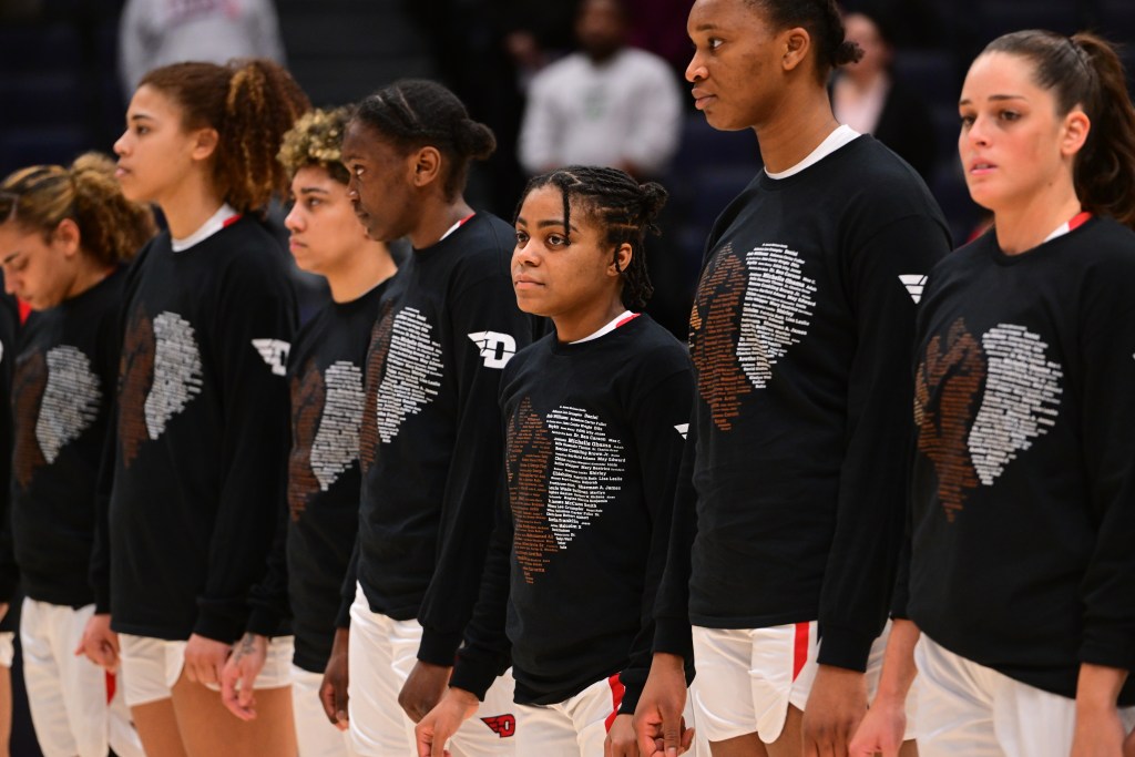 Dayton wears warm up shirts with names of Black, African American and minority names. 
