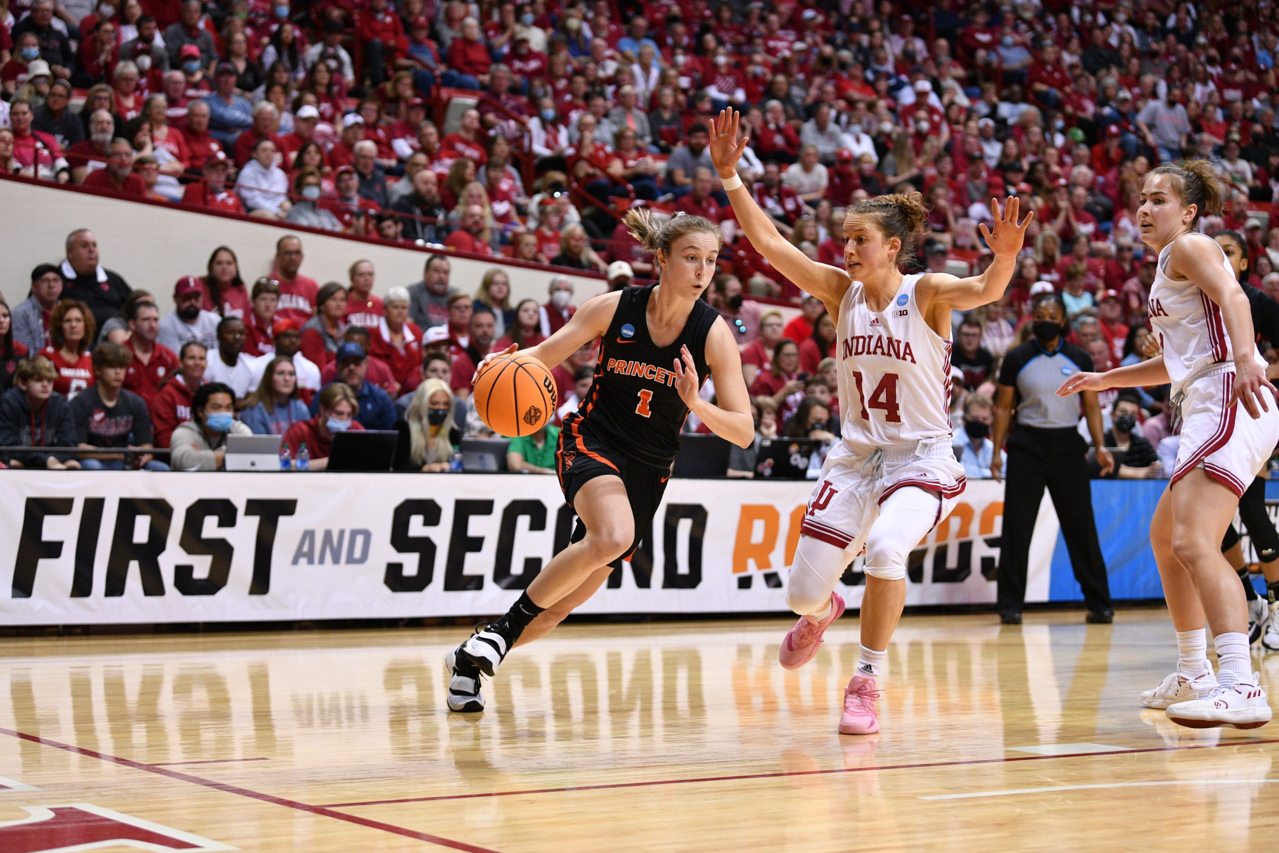 Princeton guard Abby Meyers (1) drives against Indiana guard Ali Patberg (14) in a second-round NCAA Tournament game on March 21, 2022, in Bloomington, Indiana. (Photo credit: Princeton Athletics/Sideline Photos)