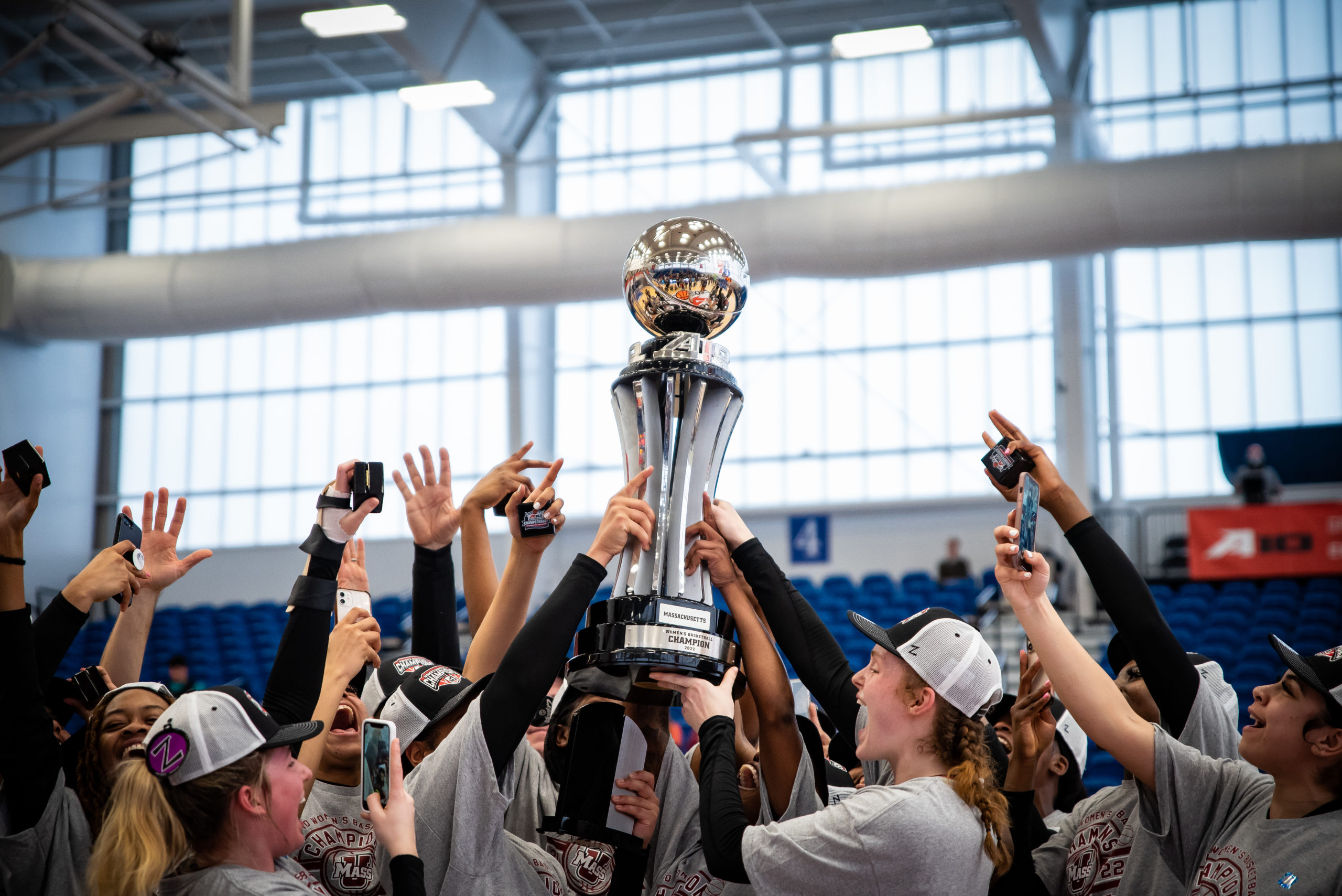 UMass women's basketball hoists the Atlantic 10 Championship trophy