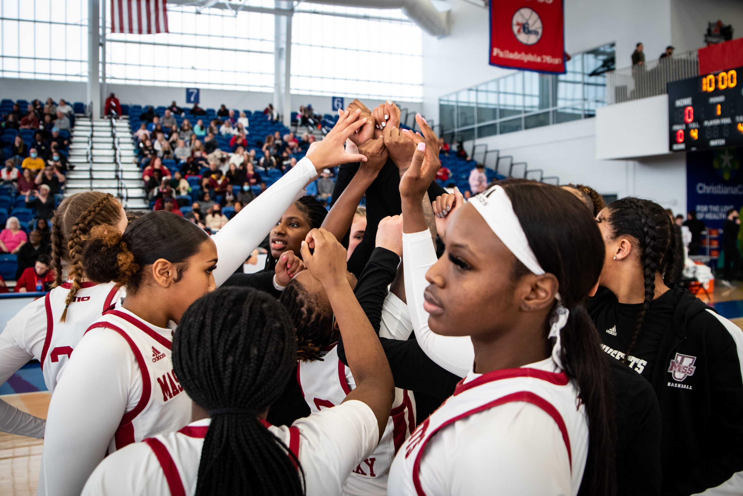 UMass huddles and puts their hands in before the game