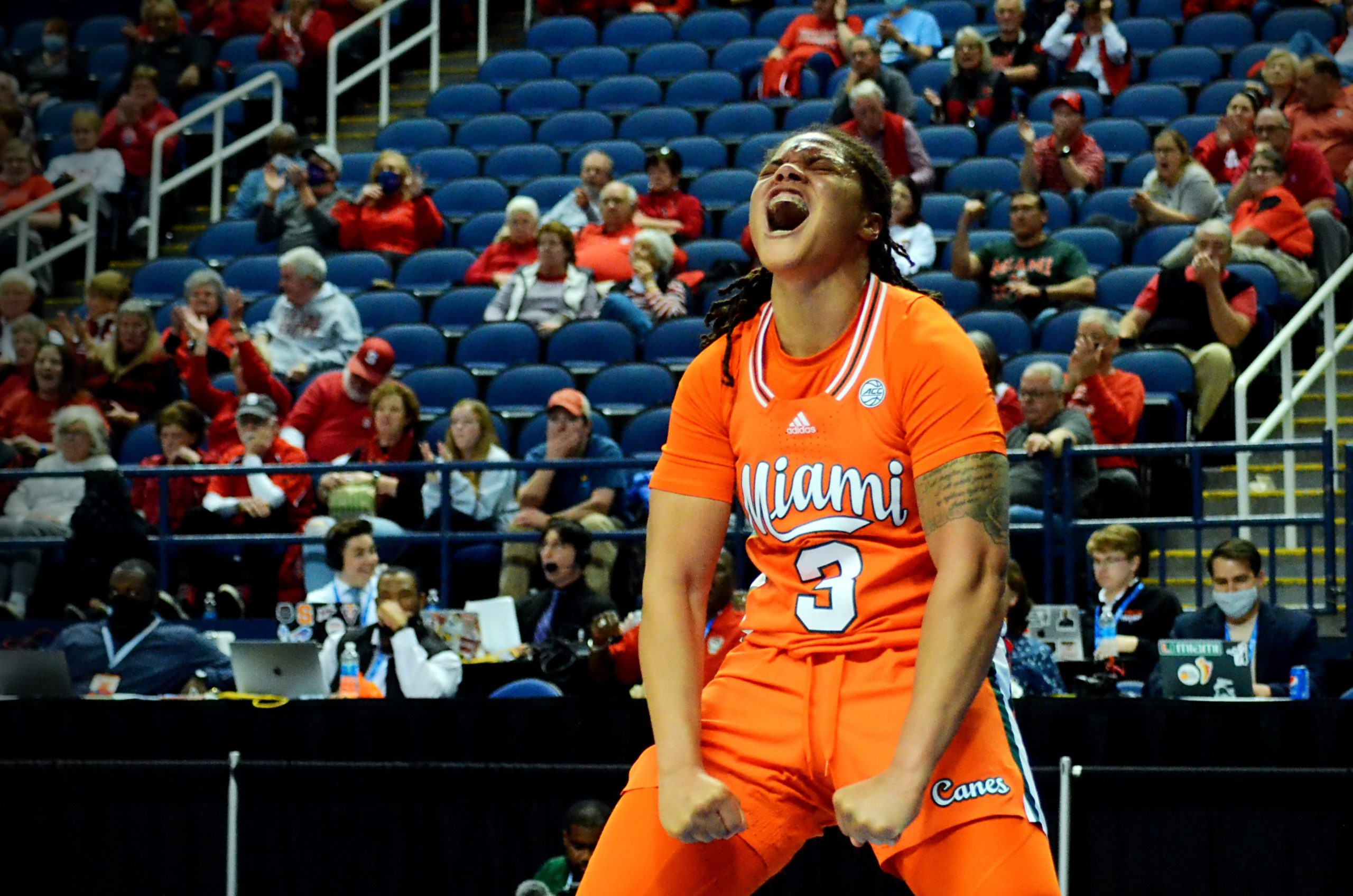 Destiny Harden screams while flexing downward in celebration