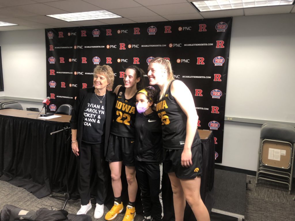 Lisa Bluder, Pepper Persley, Caitlin Clark and Monika Czinano pose for a photograph following Iowa's February 24, 2022 game against Rutgers. (Howard Megdal photo)