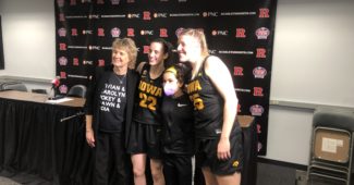 Lisa Bluder, Pepper Persley, Caitlin Clark and Monika Czinano pose for a photograph following Iowa's February 24, 2022 game against Rutgers. (Howard Megdal photo)
