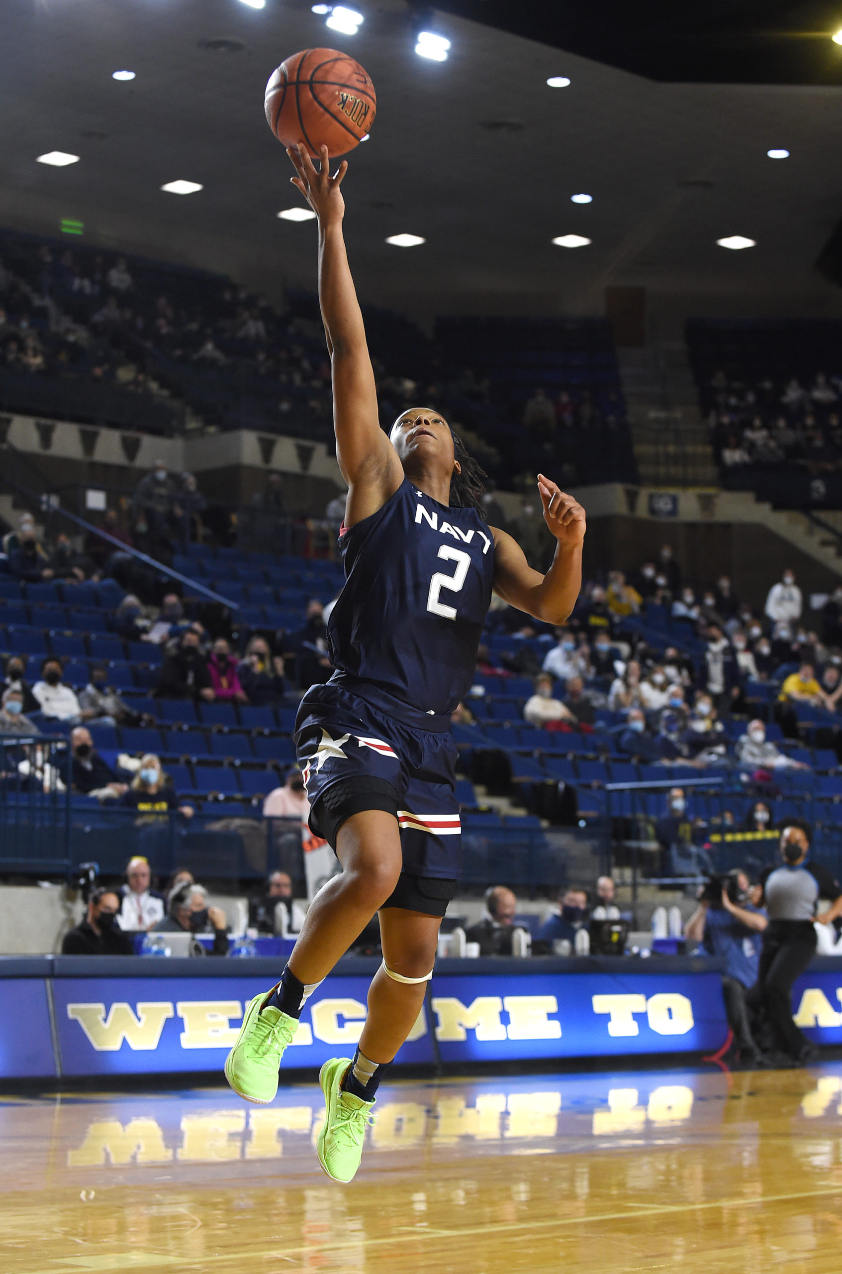 Jennifer Coleman, mid-air, lays up the ball towards the rim