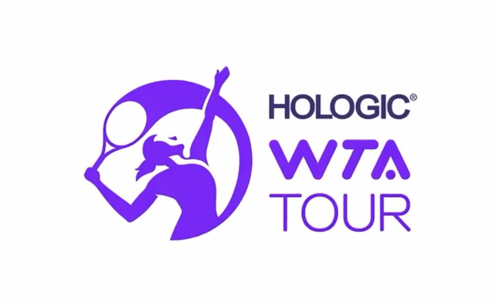A logo for the Women's Tennis Association Tour is purple and shows a woman serving in tennis.