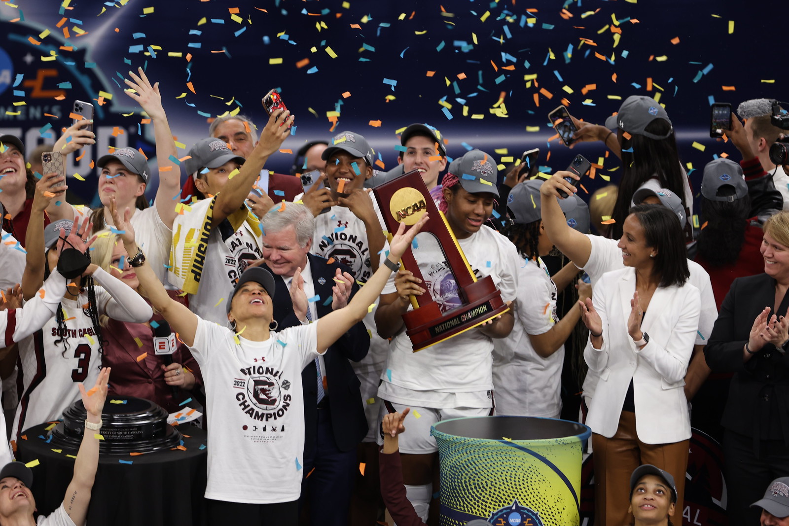 Dawn Staley lifts her arms to the sky as the confetti falls on South Carolina's 2022 national championship.