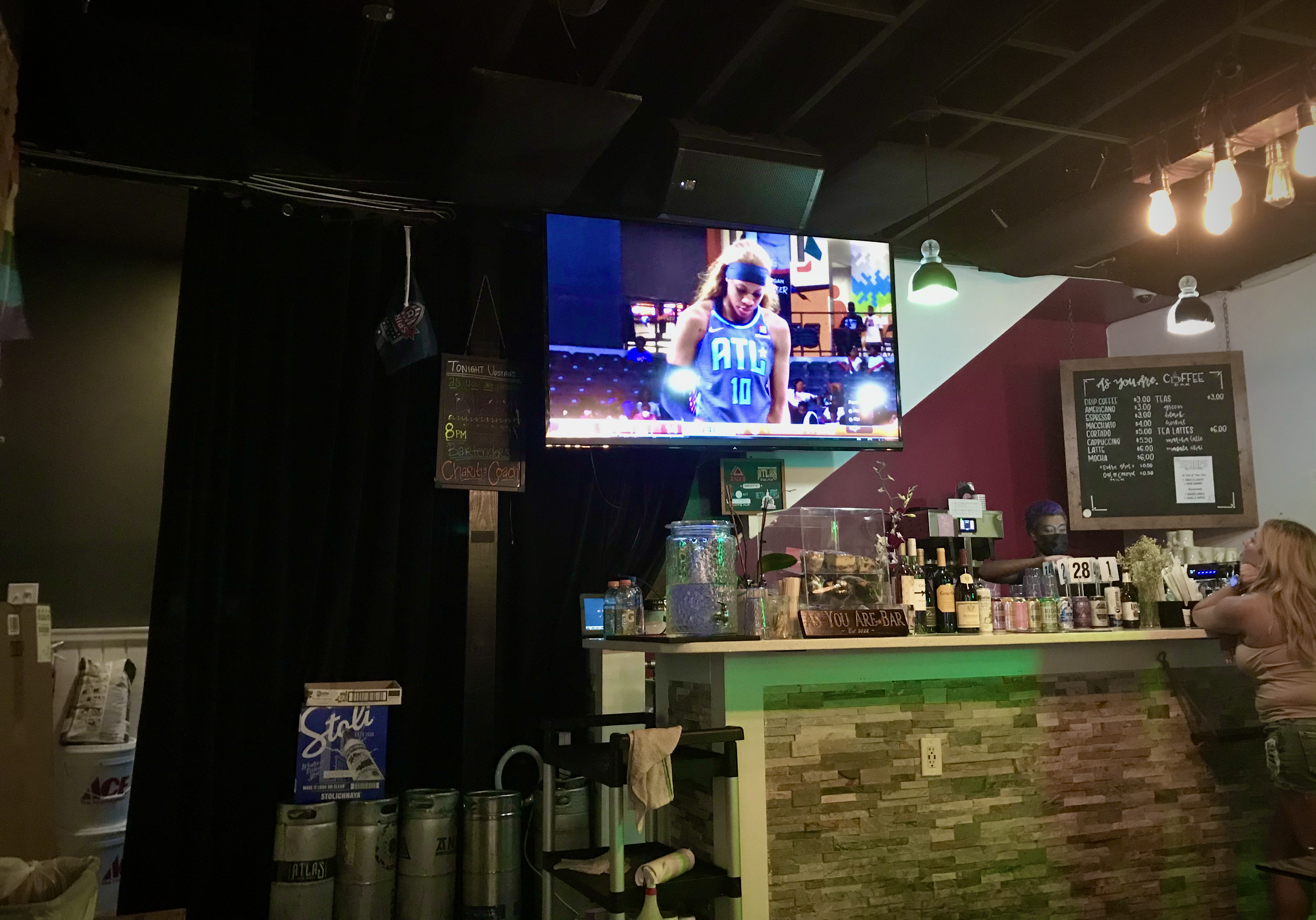 Atlanta Dream guard/forward Rhyne Howard is shown playing against the Washington Mystics on a television at As You Are, an official bar partner of the Mystics, in Washington, DC, on May 20, 2022. (Photo credit: Jenn Hatfield)