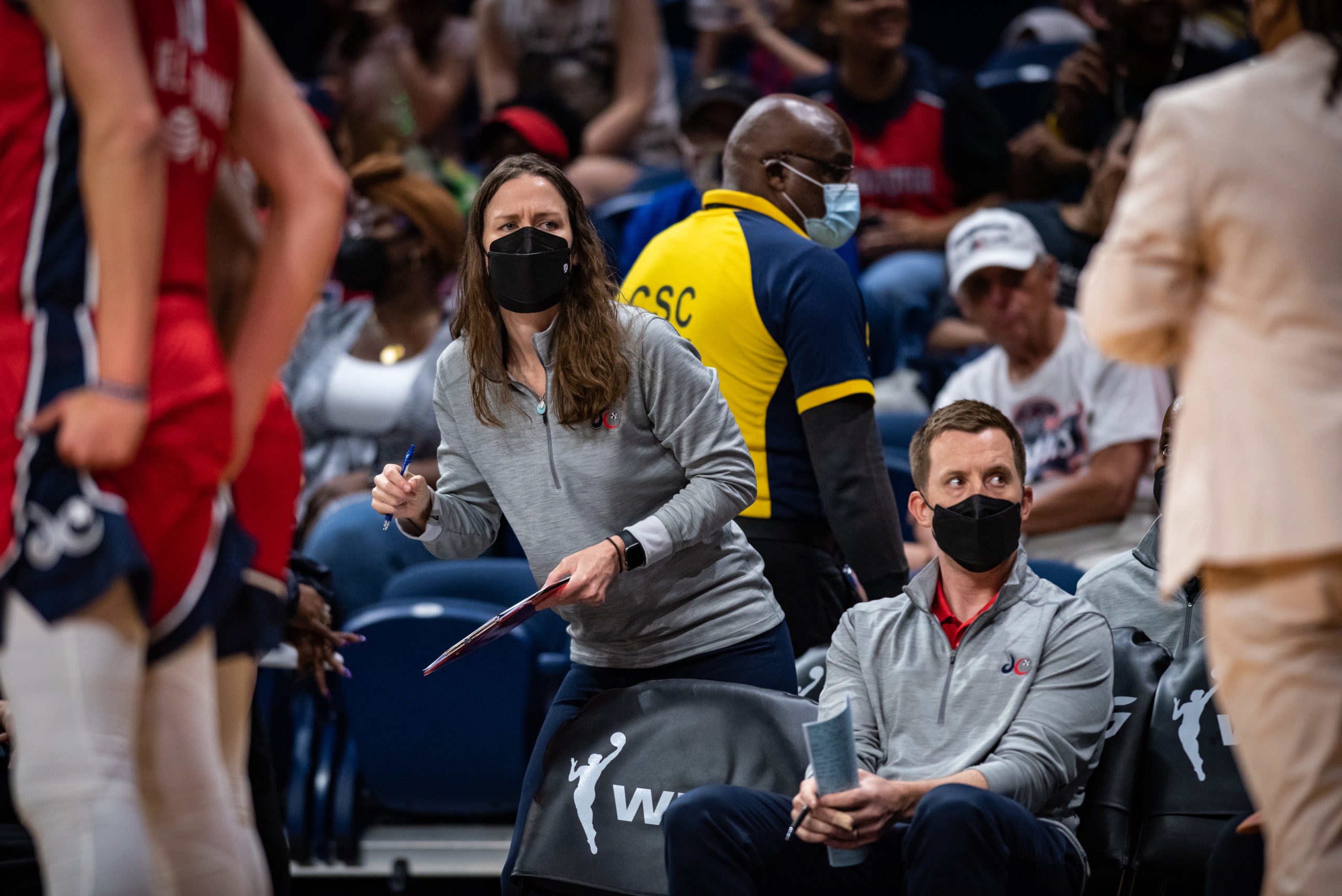 Washington Mystics assistant general manager Maria Giovannetti (left) rises to her feet during a game against the Chicago Sky on May 22, 2022.