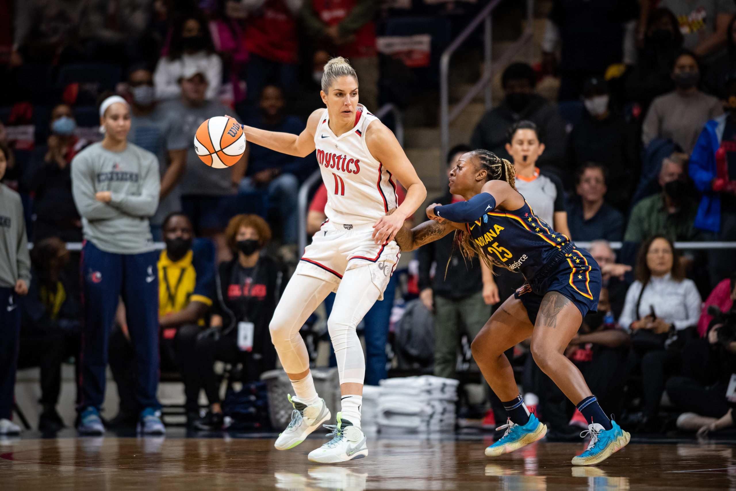 Washington Mystics forward/guard Elena Delle Donne dribbles against Indiana Fever guard Tiffany Mitchell in a game at the Entertainment and Sports Arena in Washington, DC, on May 6, 2022. (Photo credit: Domenic Allegra)