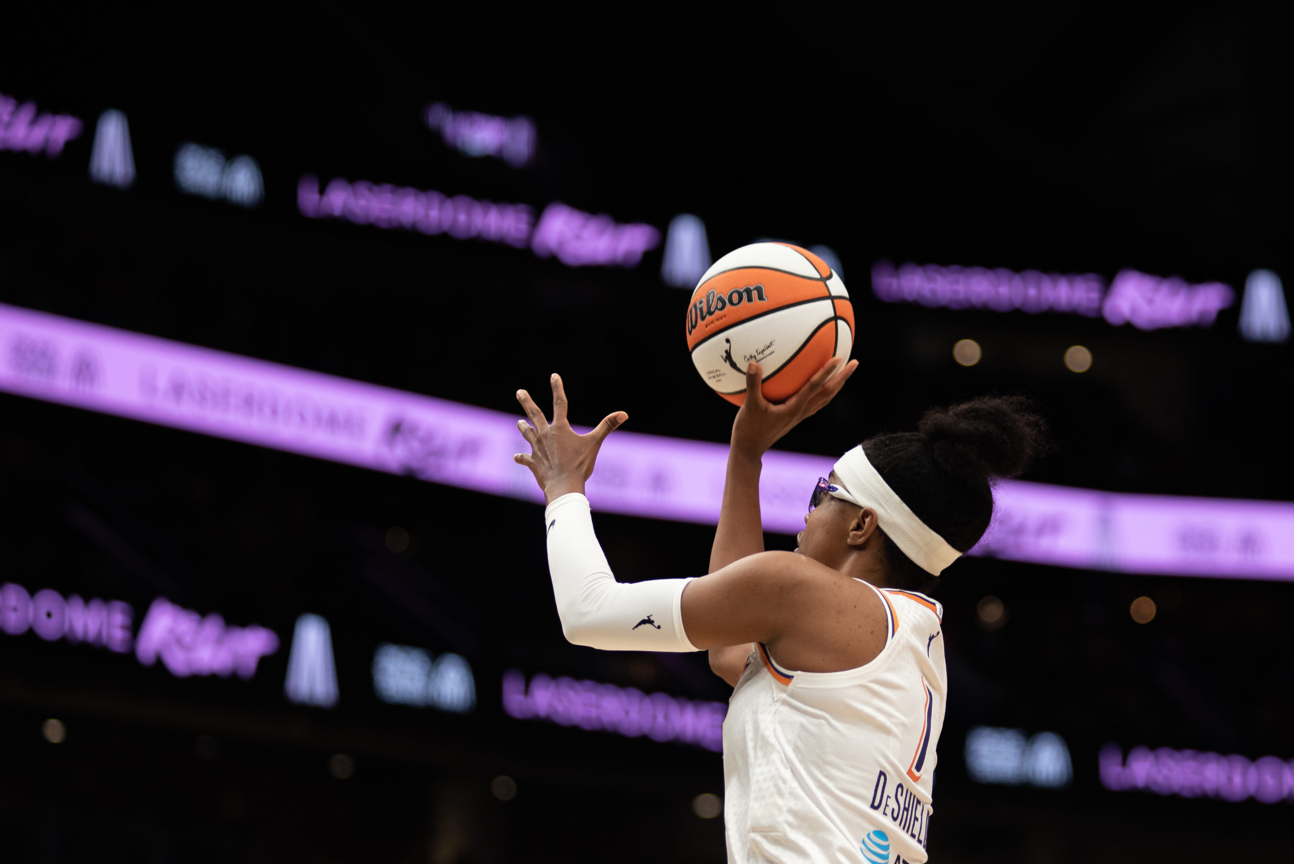 Phoenix Mercury wing Diamond DeShields in mid-air with one hand on the ball, just before taking a floater