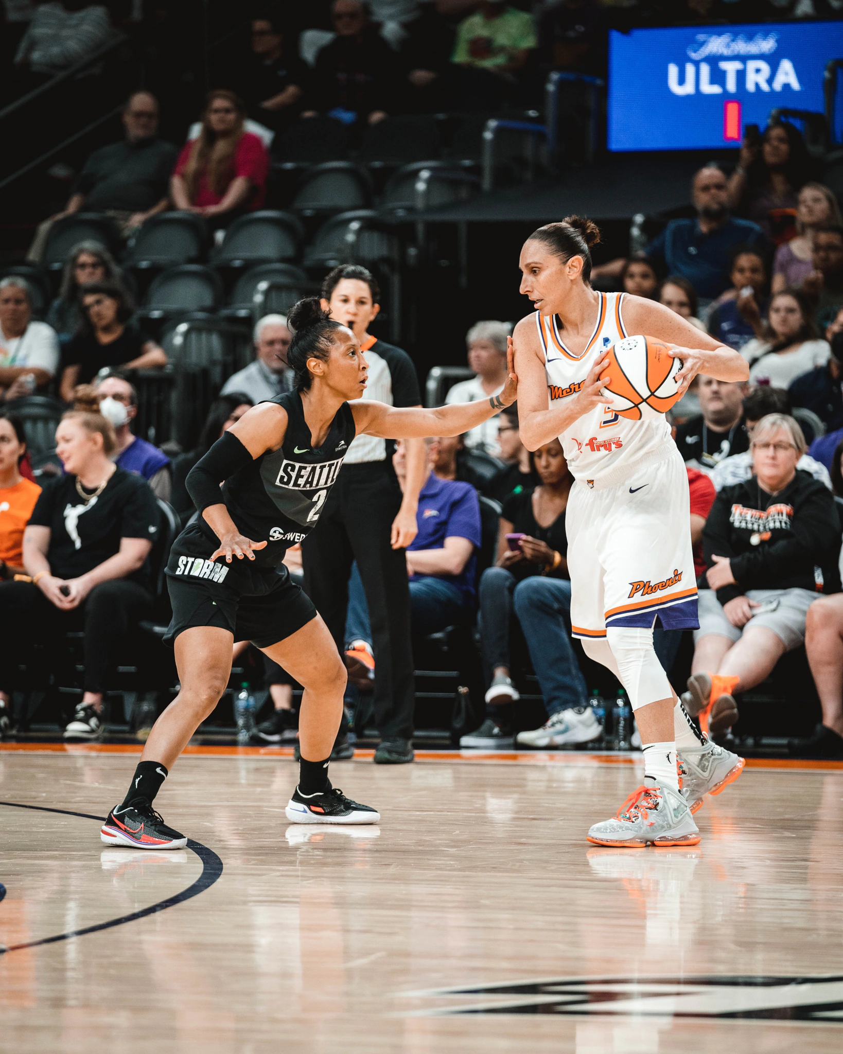 Phoenix Mercury guard Diana Taurasi readies herself to dribble as she is guarded closely by Seattle Storm guard Briann January in the teams' first meeting of the schedule