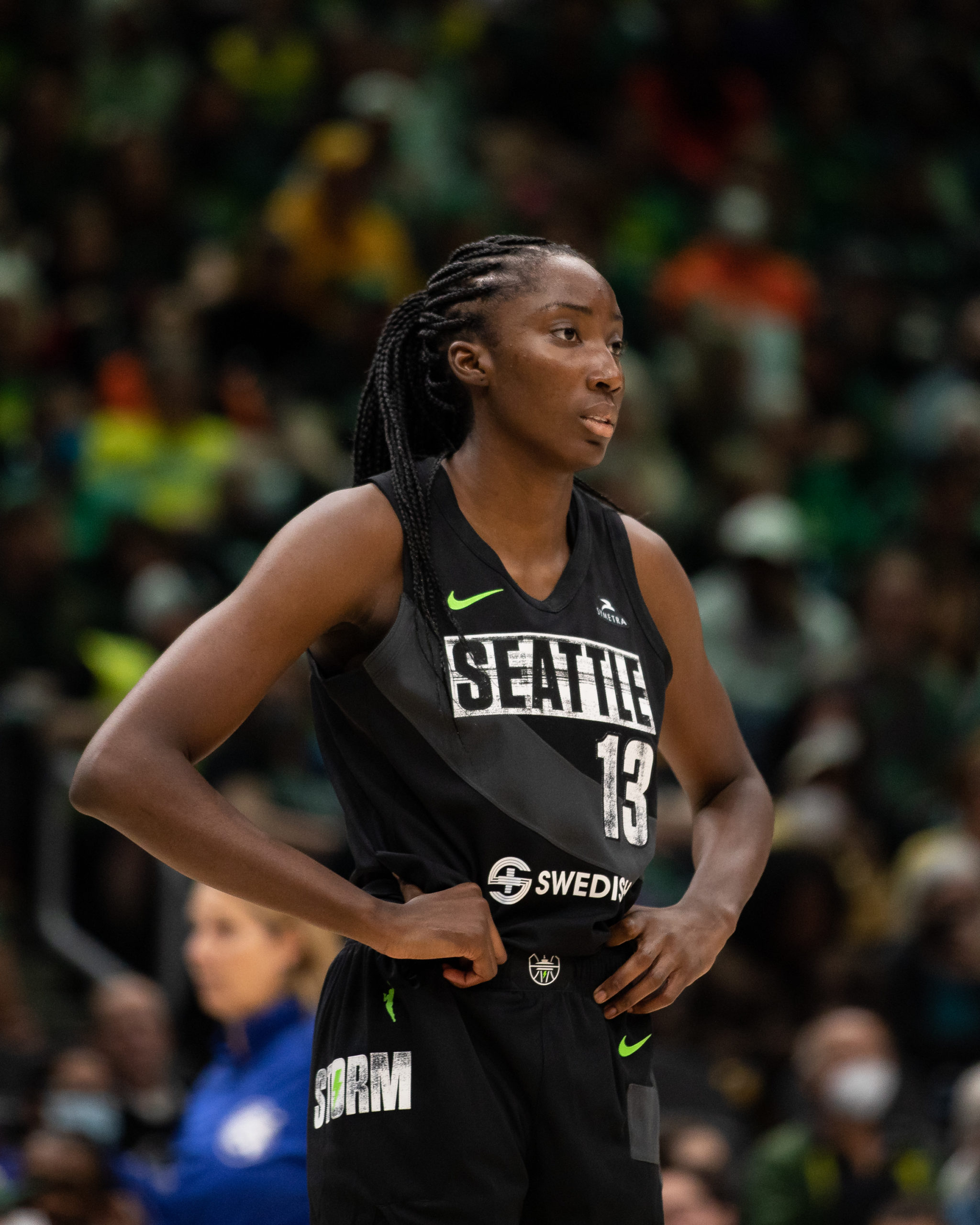 Seattle Storm big Ezi Magbegor holds her hands on her hips while looking out