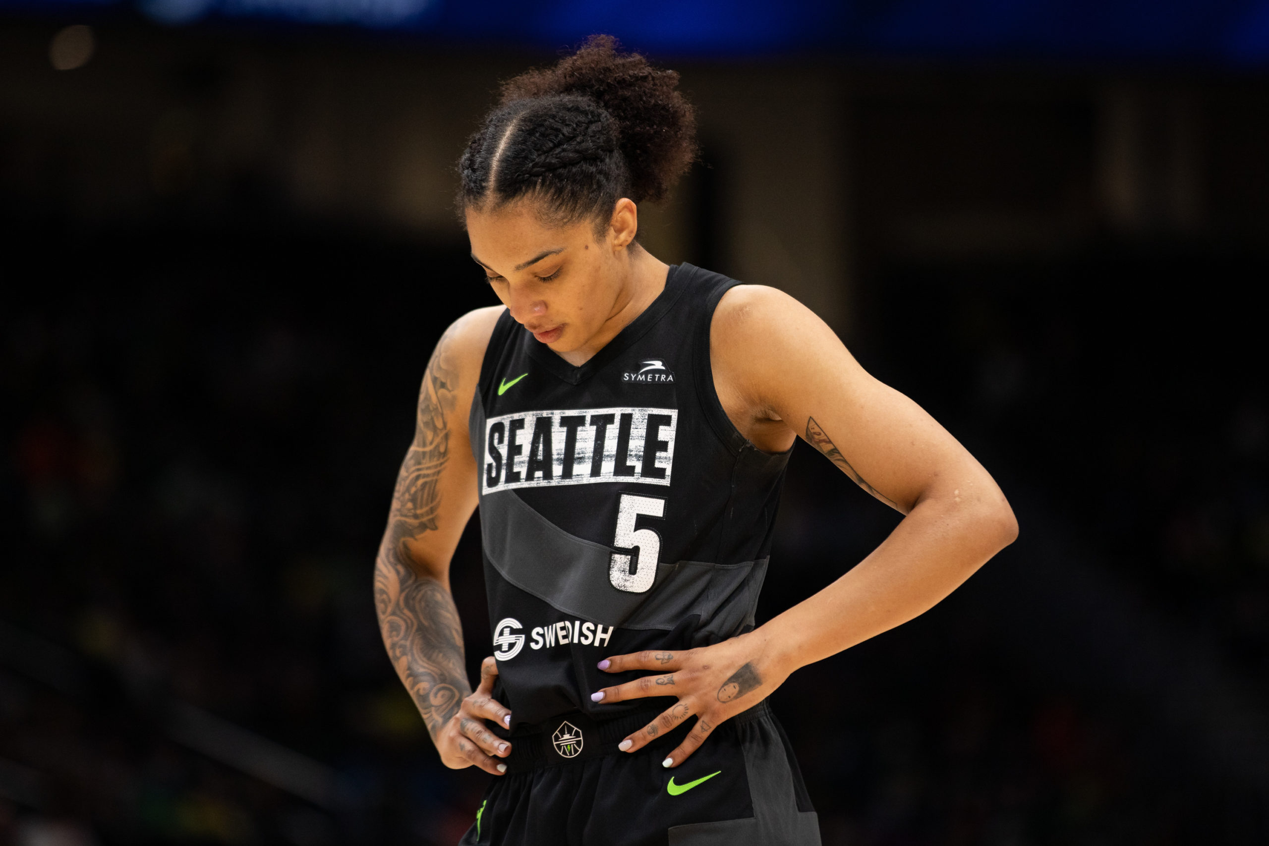 Seattle Storm off-ball guard Gabby Williams with her hand on her hips and looking down