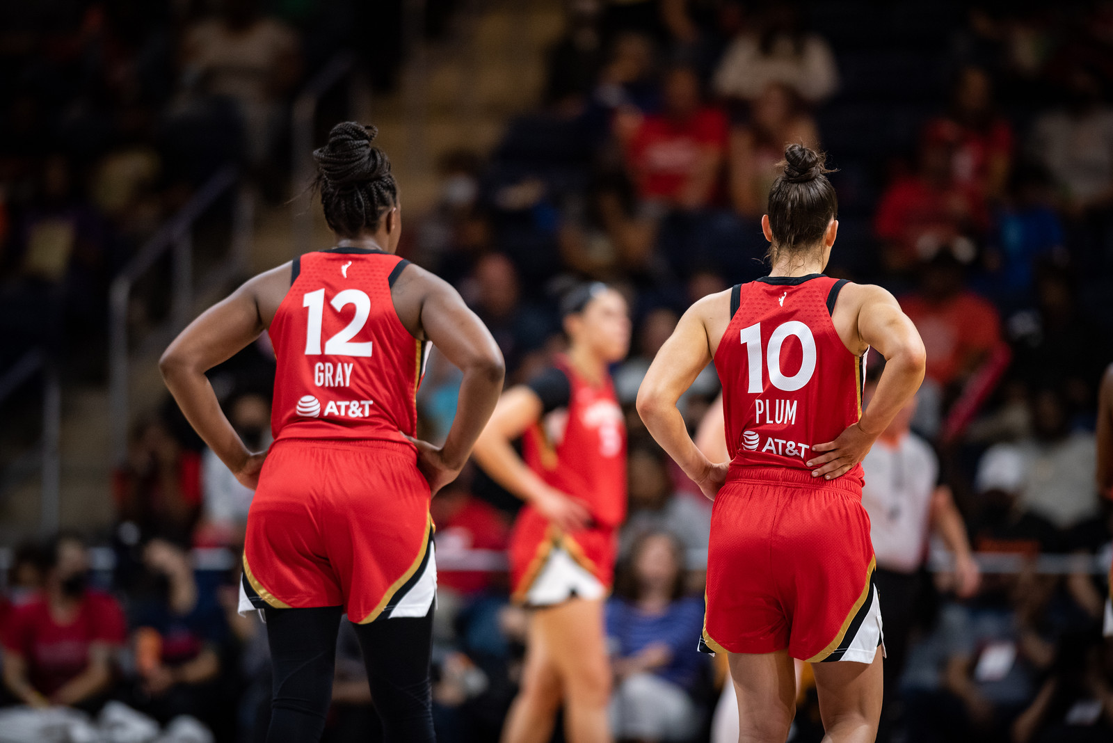 Las Vegas Aces point guards Chelsea Gray and Kelsey Plum stand with their hands on their hips facing away from the camera