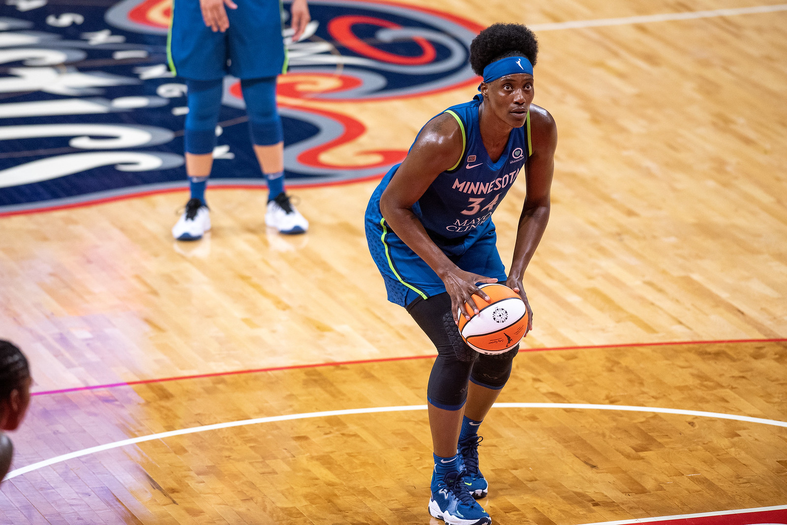 Sylvia Fowles holds the ball at the free-throw line and crouches as she readies for a free-throw for the Minnesota Lynx
