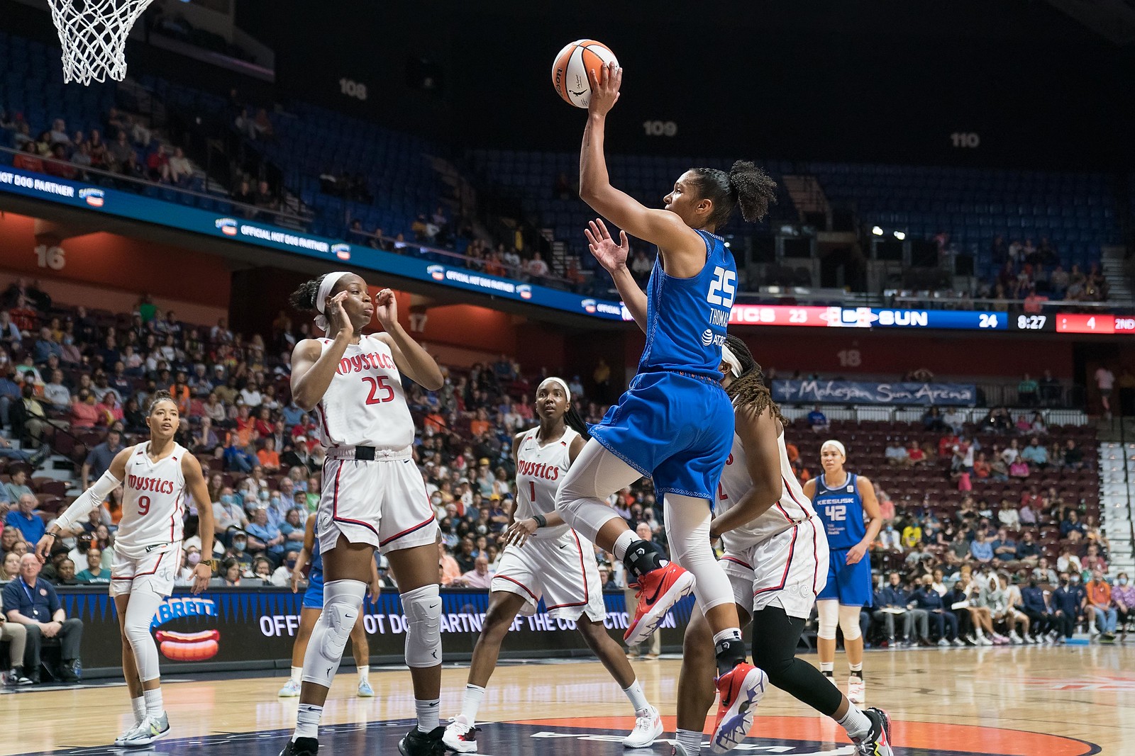Connecticut Sun big Alyssa Thomas jumps from the low post off of one foot to shoot a one-handed floater, as Washington Mystics defenders watch on