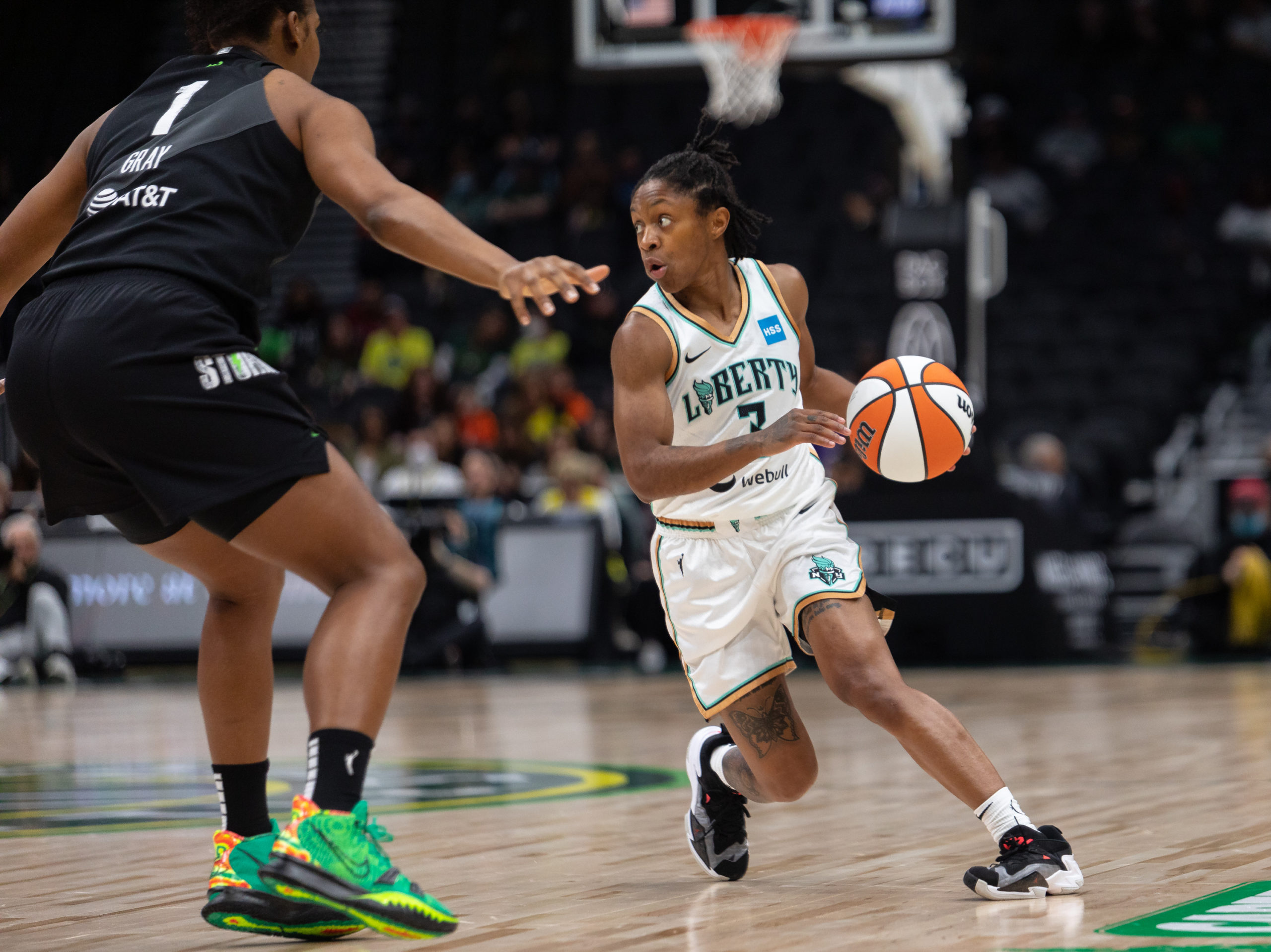 New York Liberty point guard Crystal Dangerfield begins a crossover off her left foot, as she surveys the court to her right
