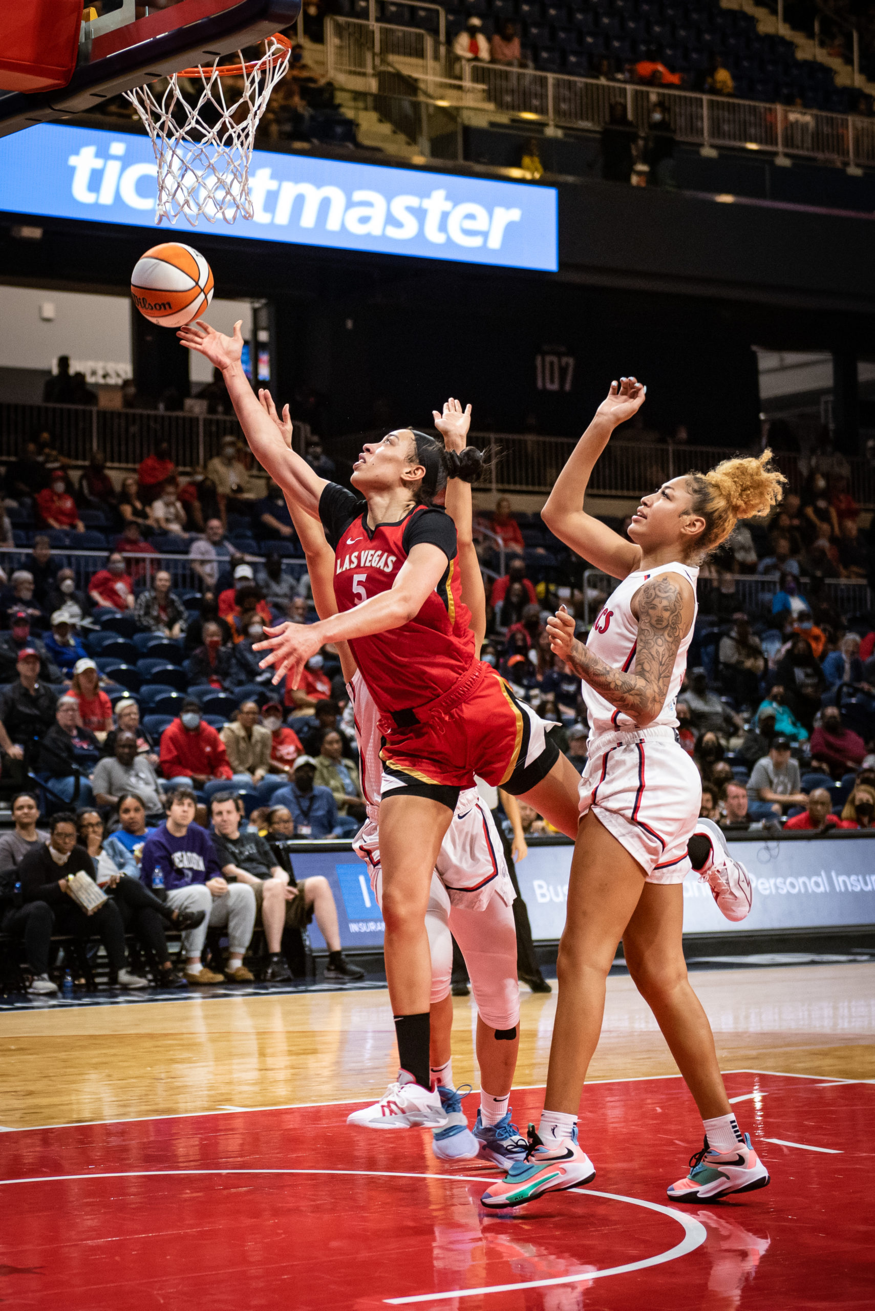 Dearica Hamby shoots a layup with her limbs fully extended.