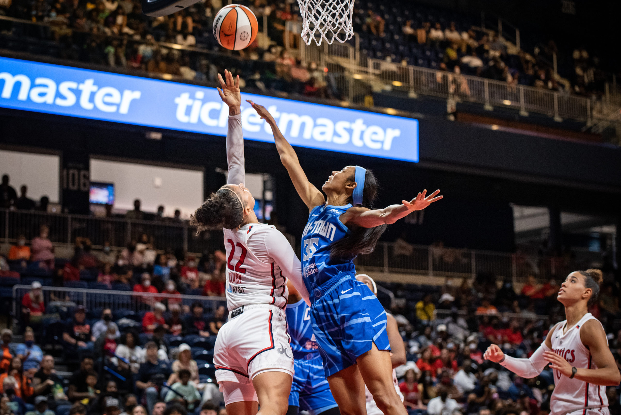 Mystics off-ball guard Alysha Clark (22) tosses a layup over Sky combo forward Rebekah Gardner (35) as Natasha Cloud (9) looks on from behind.