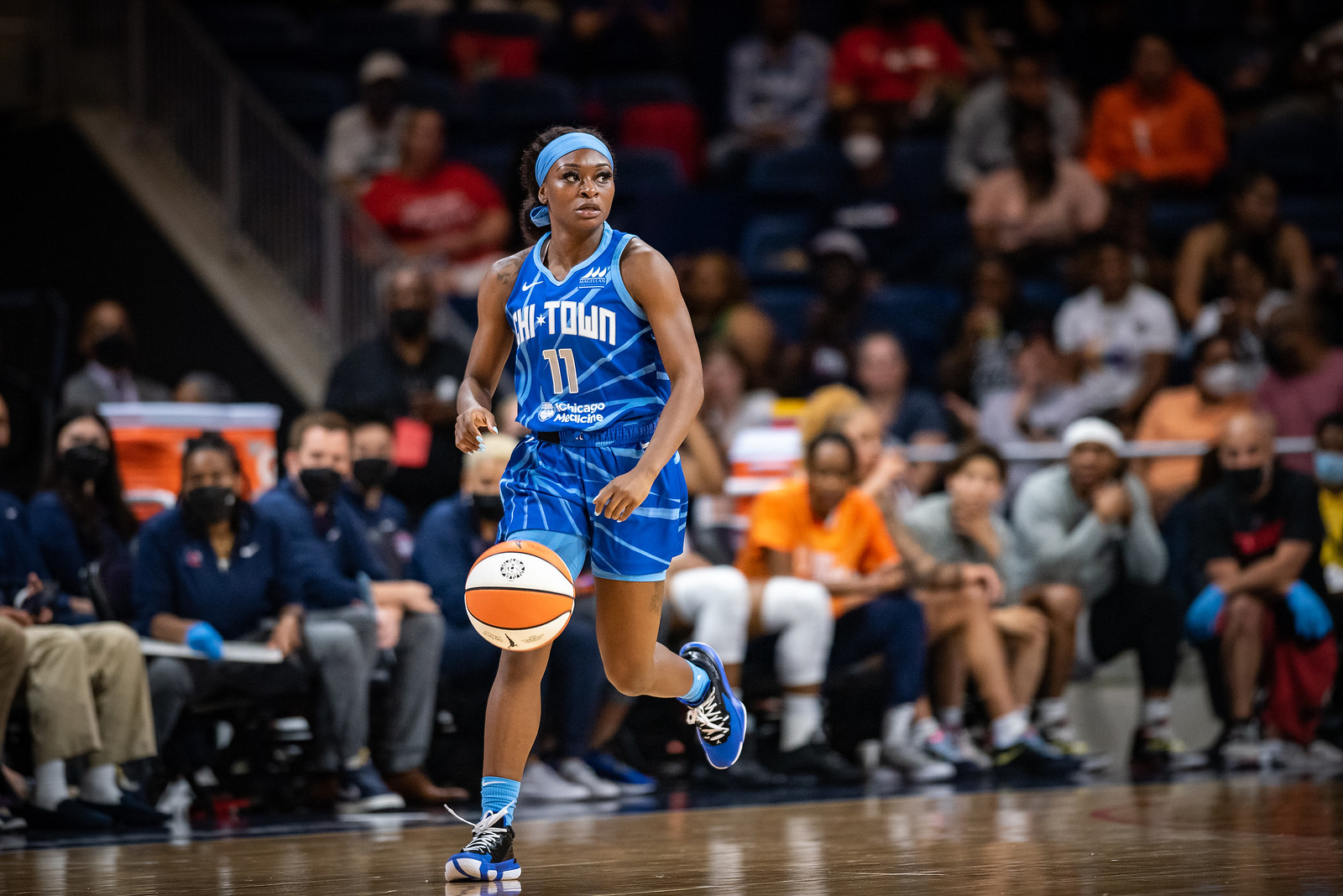 Chicago Sky point guard Dana Evans dribbles up the court around the halfcourt line while looking across the court