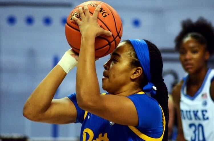 Pittsburgh guard Dayshanette Harris is shown in profile view shooting the ball, with a Duke player in the background.