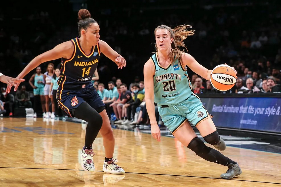 Liberty point guard Sabrina Ionescu (20) drives past Fever point guard Bria Hartley (14).
