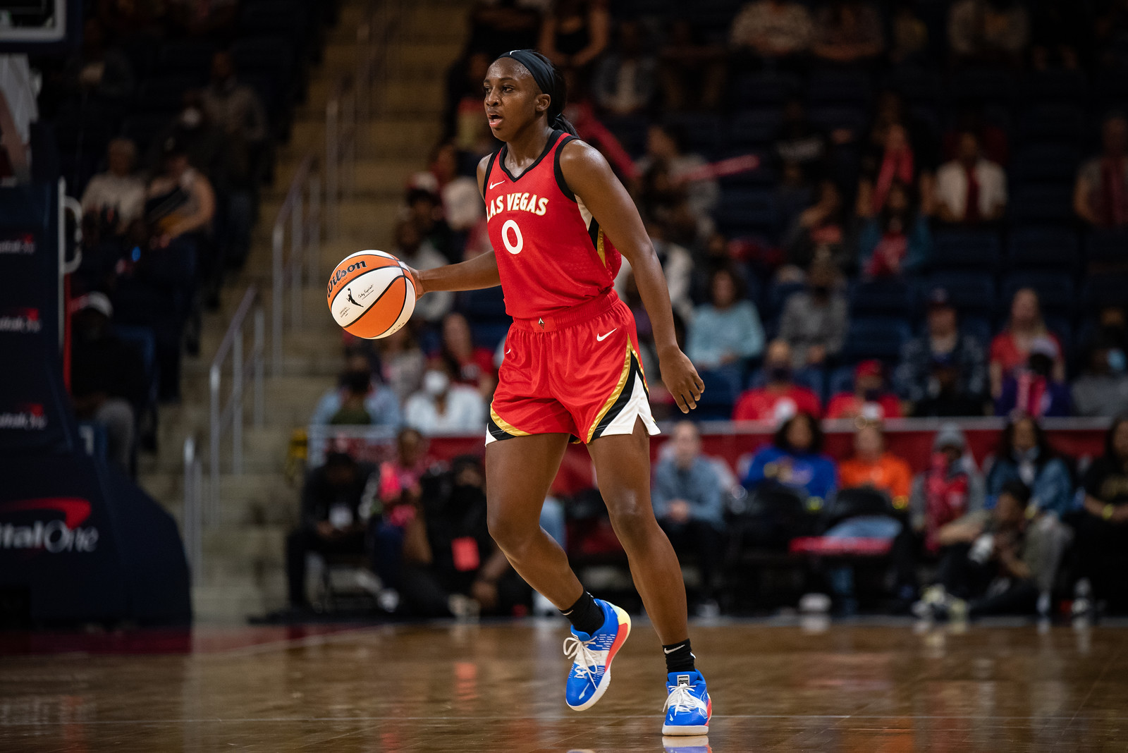 Las Vegas Aces wing Jackie Young has the ball at the top of her dribble while looking out the court